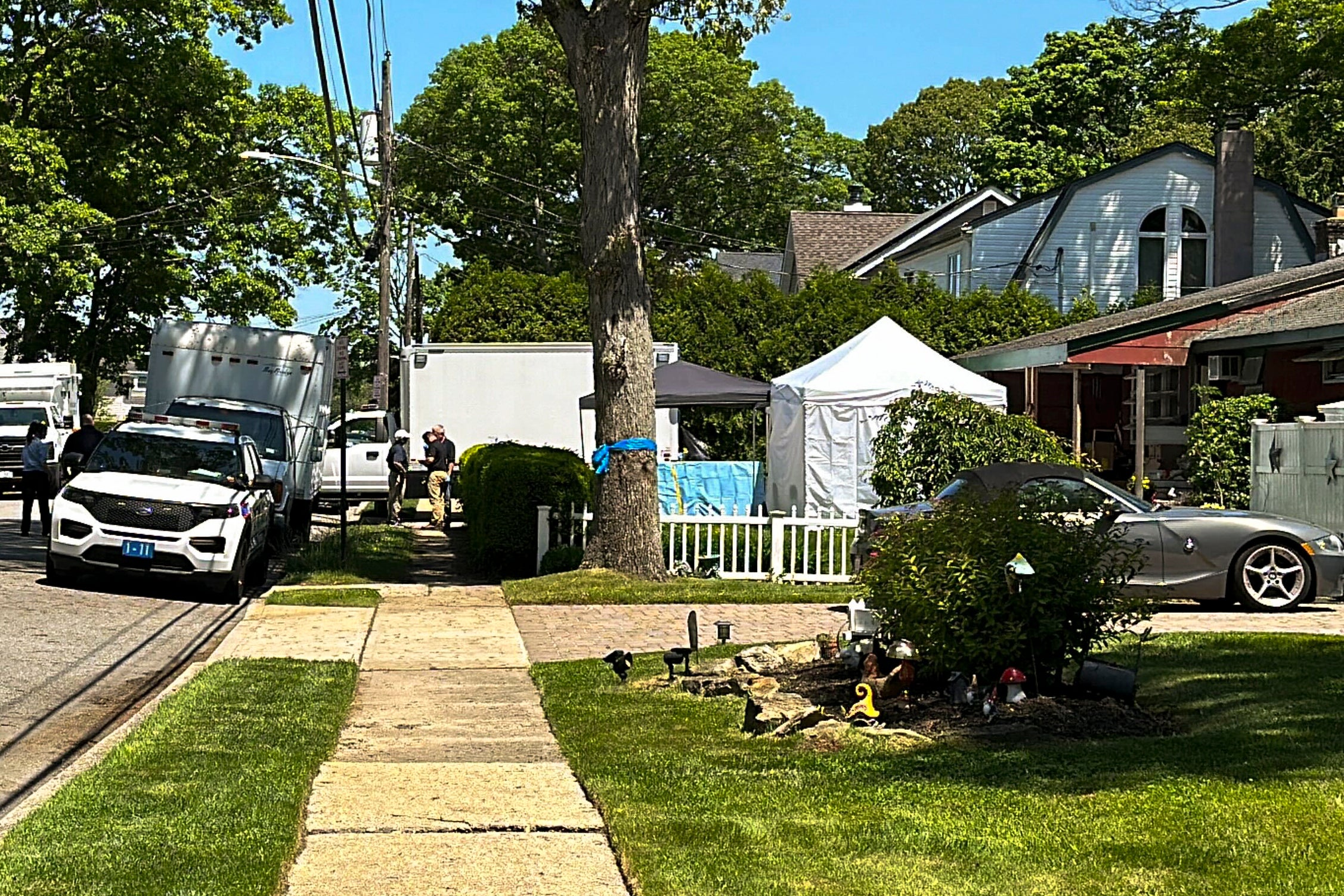 Suffolk County police outside the home of Rex Heuermann during the latest search in May