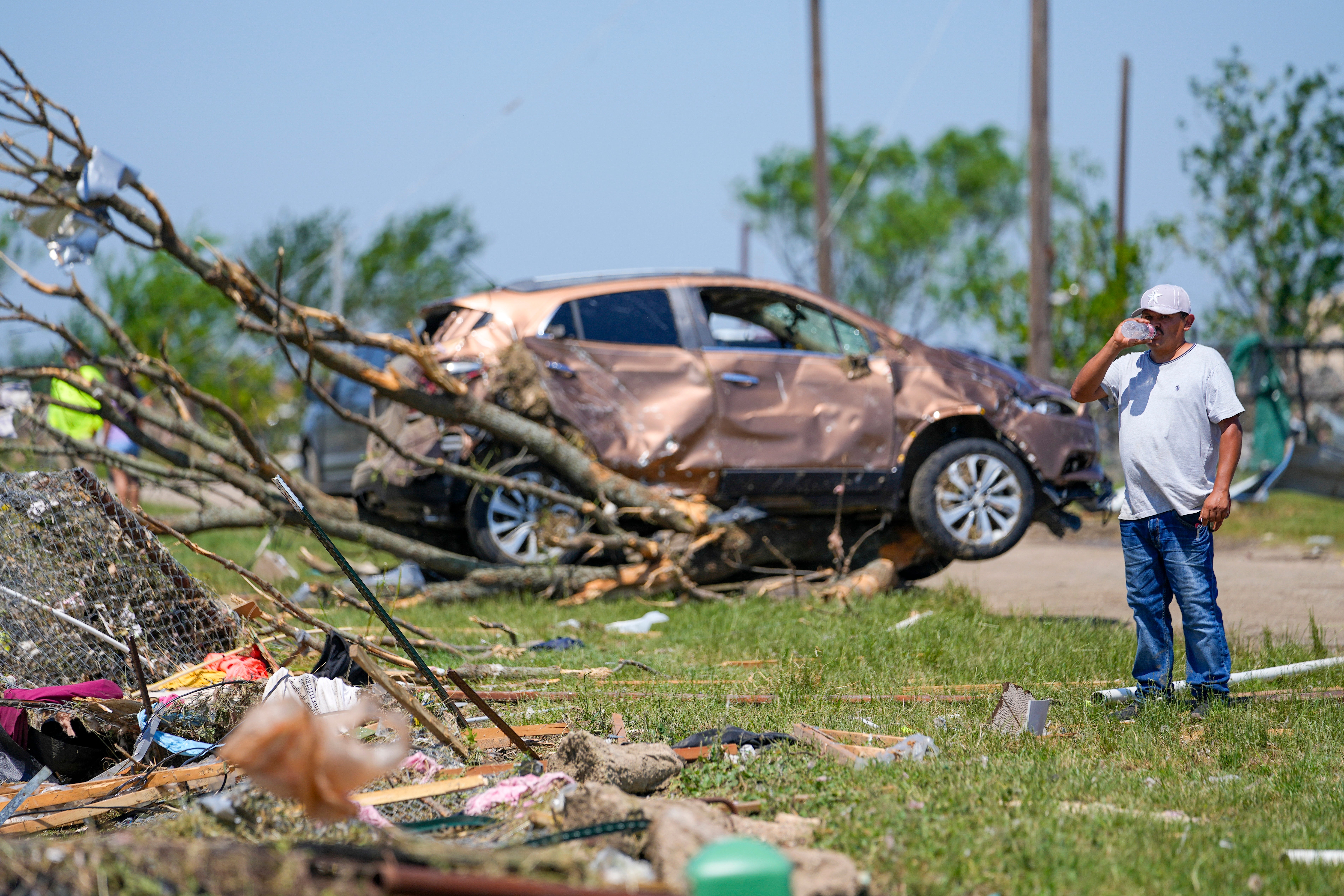 A man surveys damage to a neighbor's home after a deadly tornado rolled through, Sunday, May 26, 2024, in Valley View, Texas