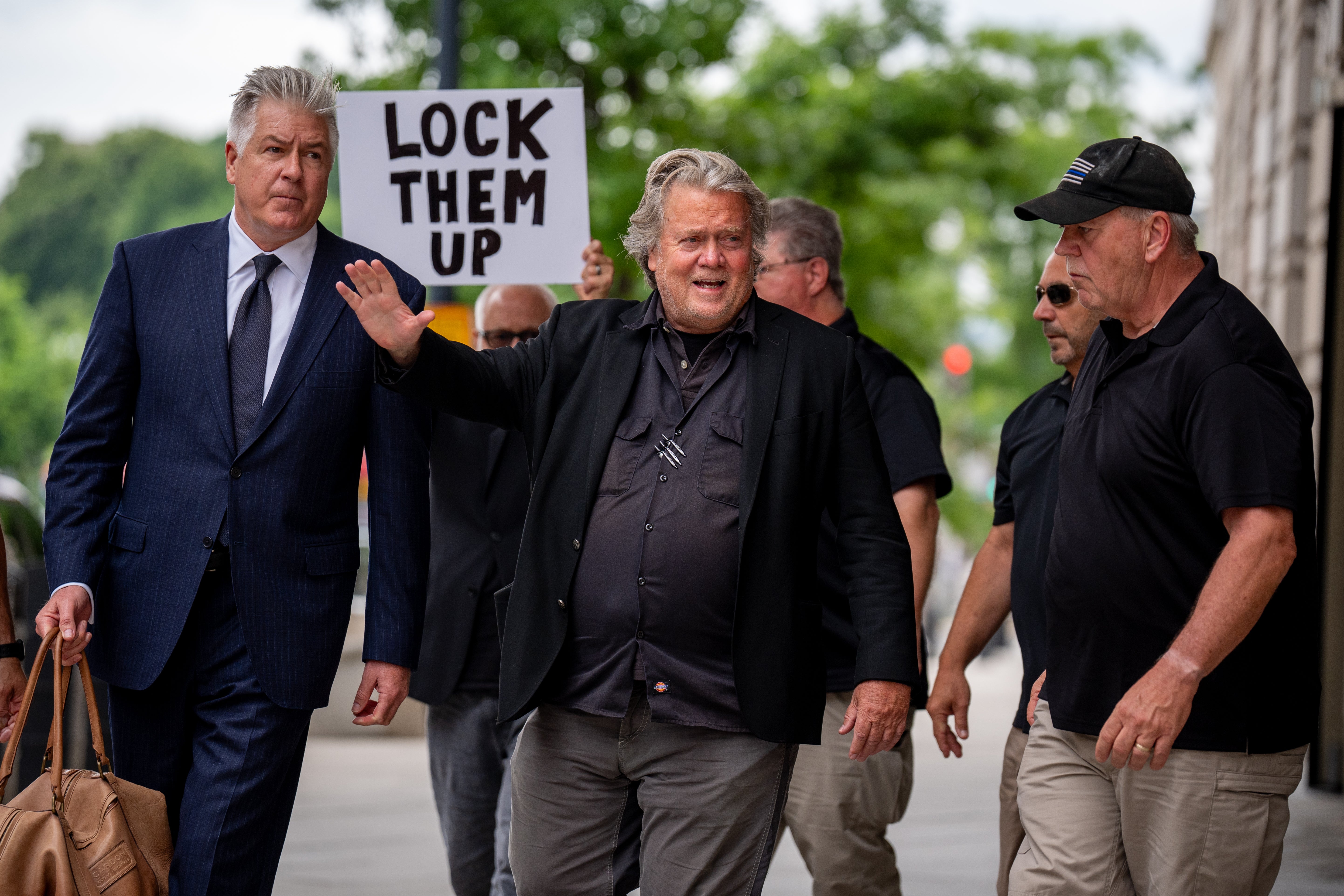 A protester greets Bannon as he arrives at a federal courthouse in Washington DC for sentencing on June 6