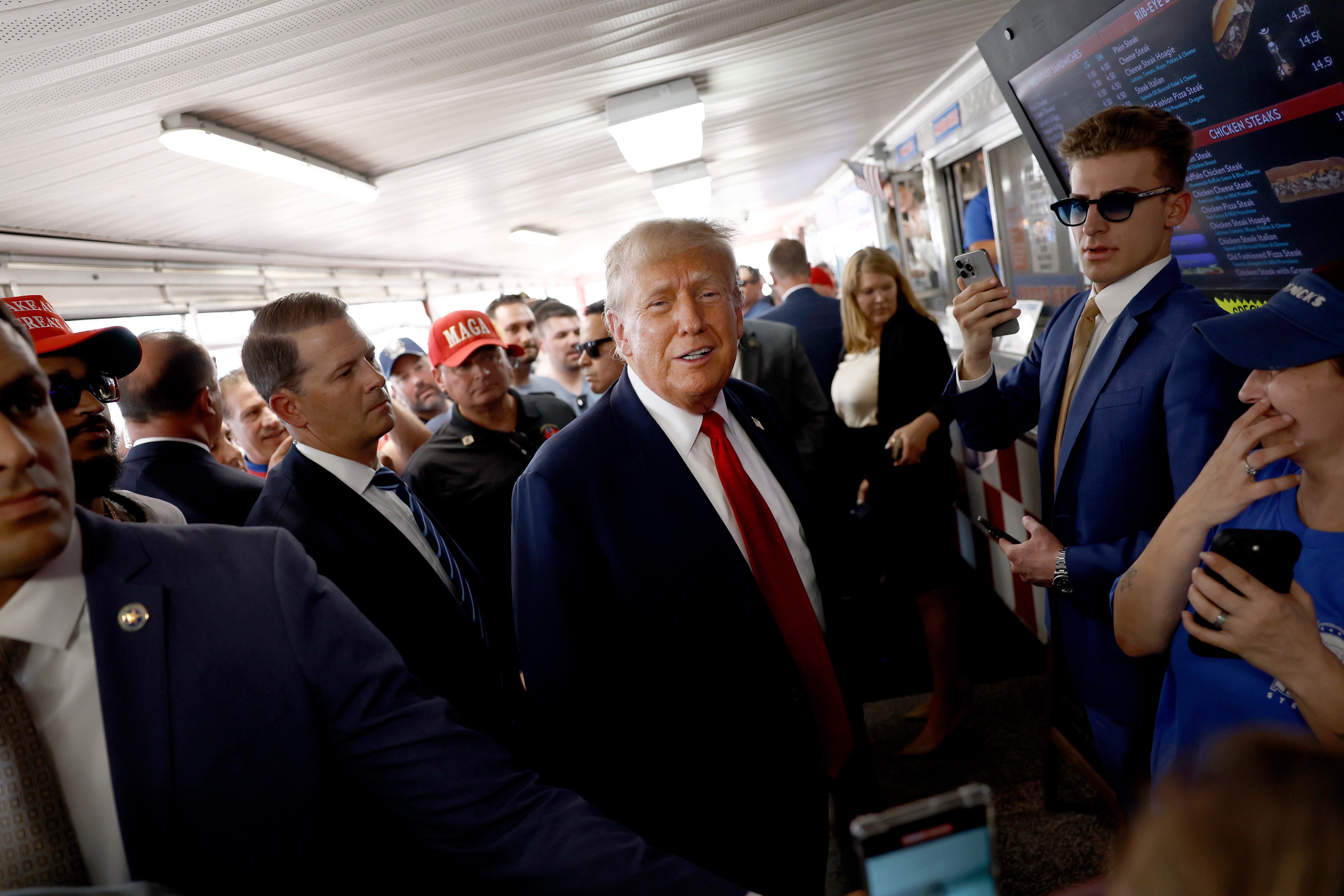 Republican presidential candidate, former president Donald Trump poses for photos with supporters at sandwich stop Tony and Nick’s steaks in Philadelphia. A former Trump confidant says he made Nazi jokes in front of Jewish executives.