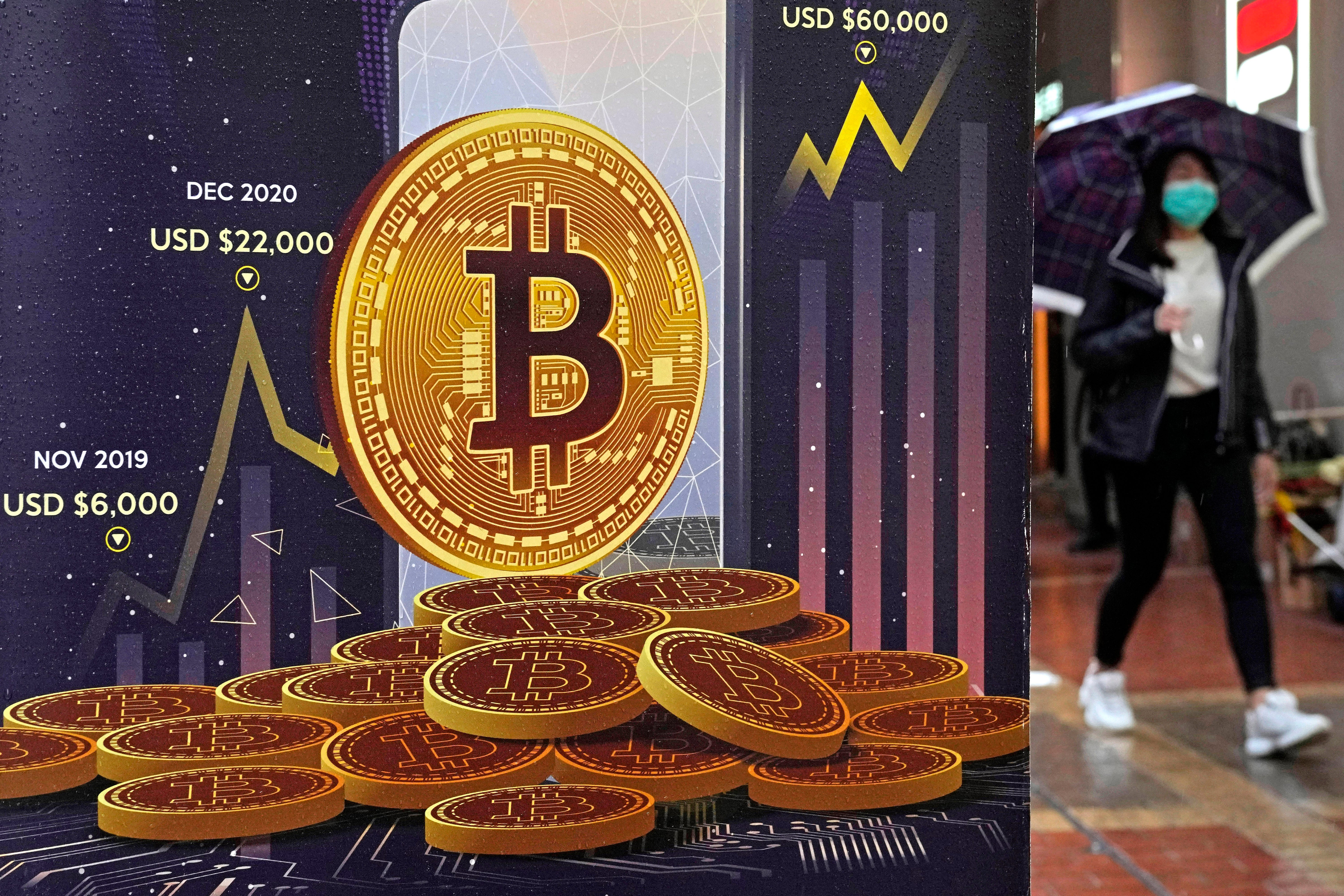 An advertisement for Bitcoin cryptocurrency is displayed on a street in Hong Kong, on Feb. 17, 2022. Bitcoin briefly hit an all-time high Tuesday, March 5, 2024, with the world's largest cryptocurrency surpassing $68,800, according to CoinMarketCap