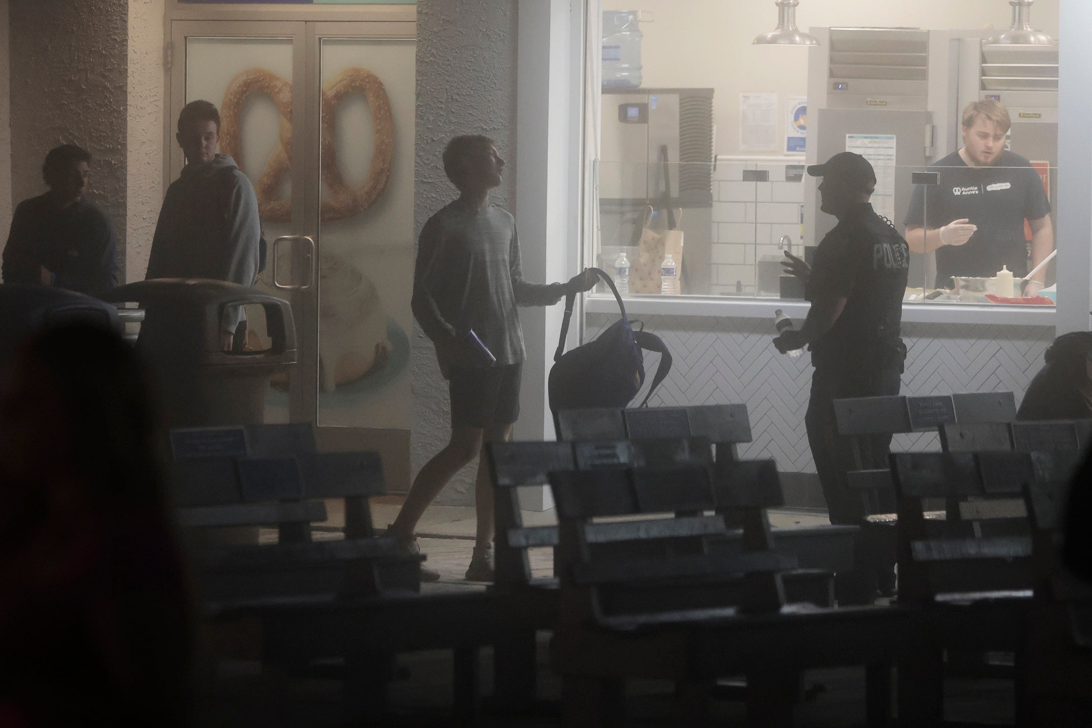 A young man shows his backpack to a police officer in Ocean City, N.J., on Memorial Day weekend. Wildwood, New Jersey, is expected to pass a backpack ban to combat teen disturbances at the boardwalk