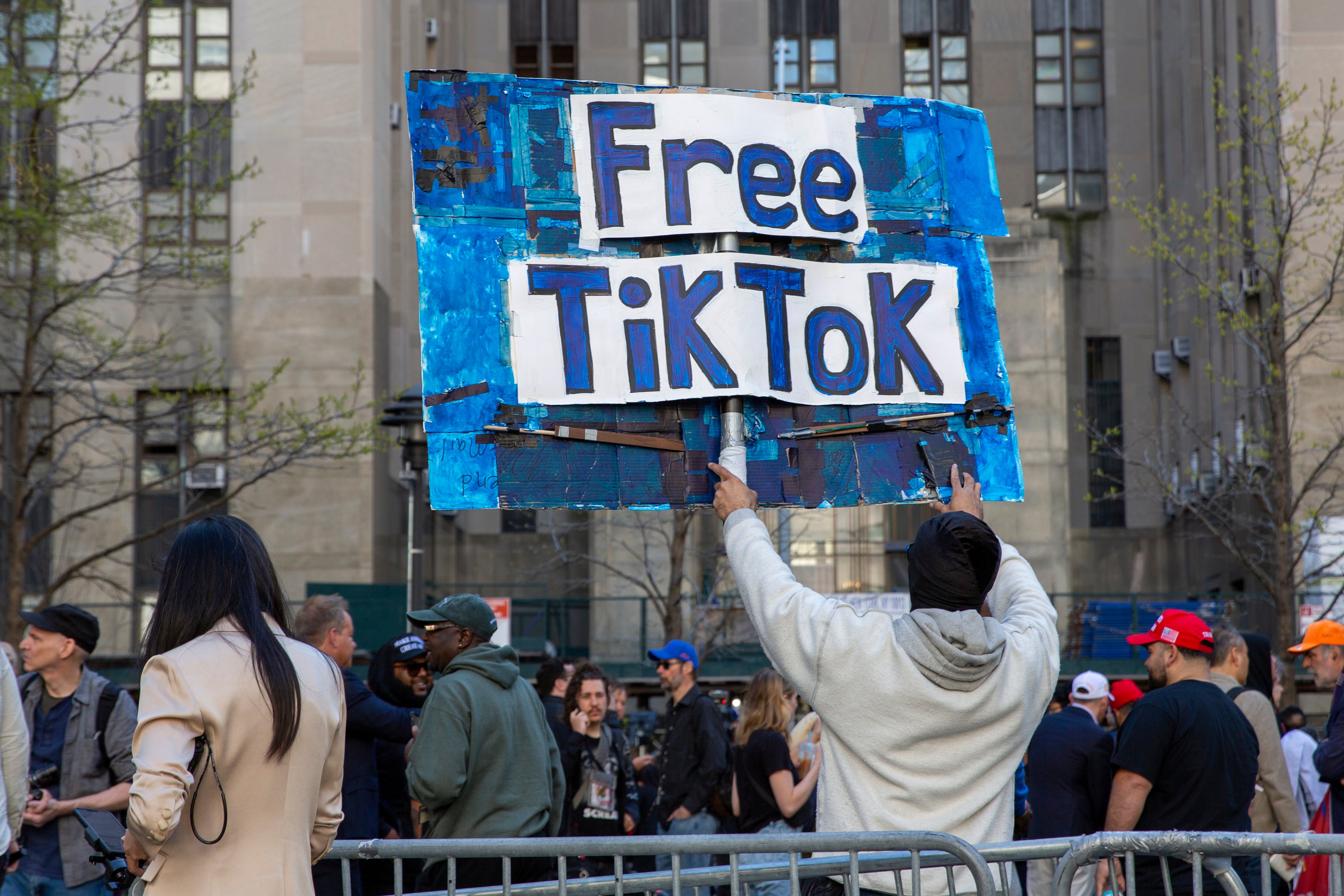 A man carries a Free TikTok sign in front of the courthouse where the hush-money trial of Donald Trump got underway April 15, 2024, in New York.