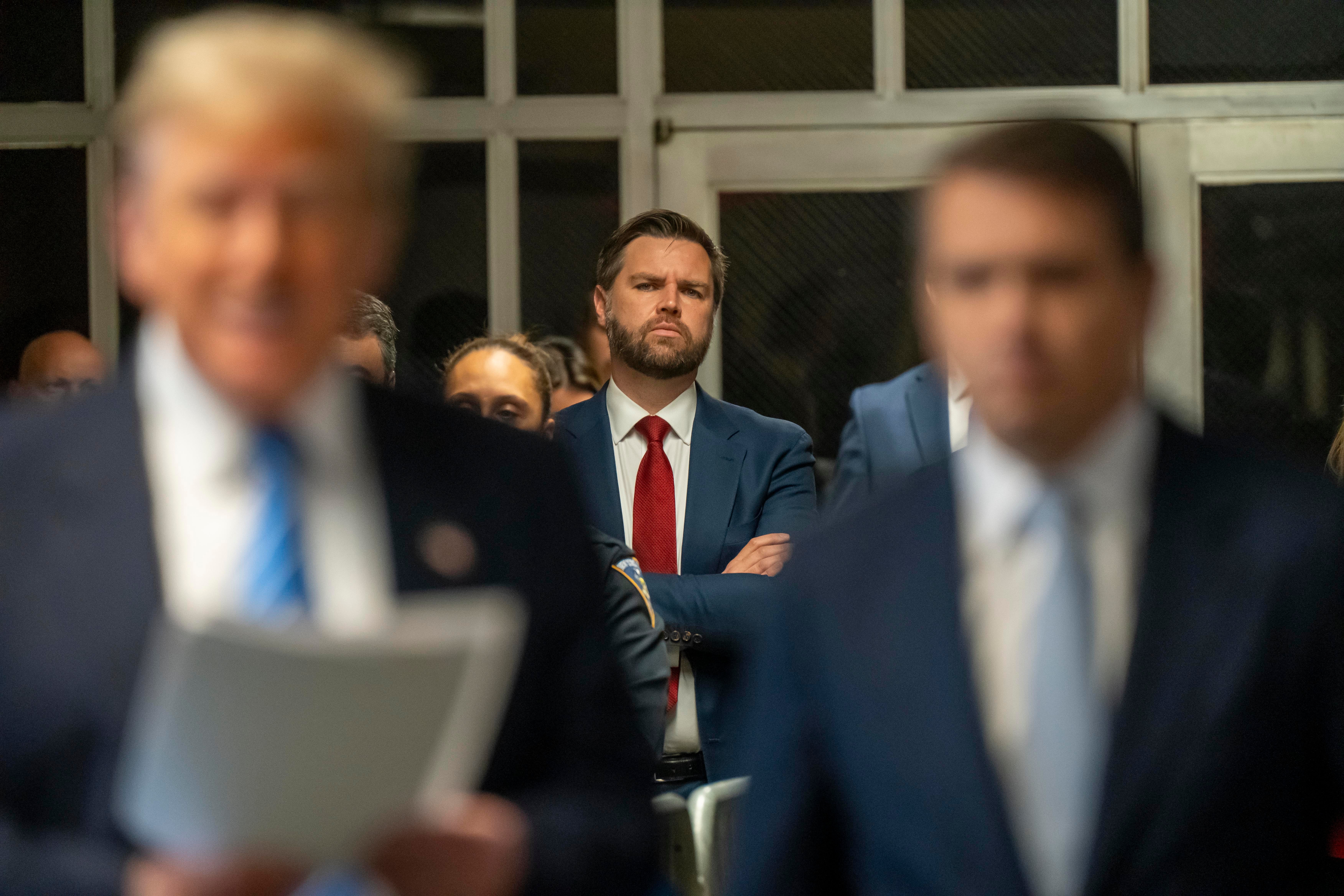 Sen. JD Vance looks on as former President Donald Trump speaks to the media during Trump’s trial for allegedly covering up hush money payments at Manhattan Criminal Court on May 13, 2024 in New York City