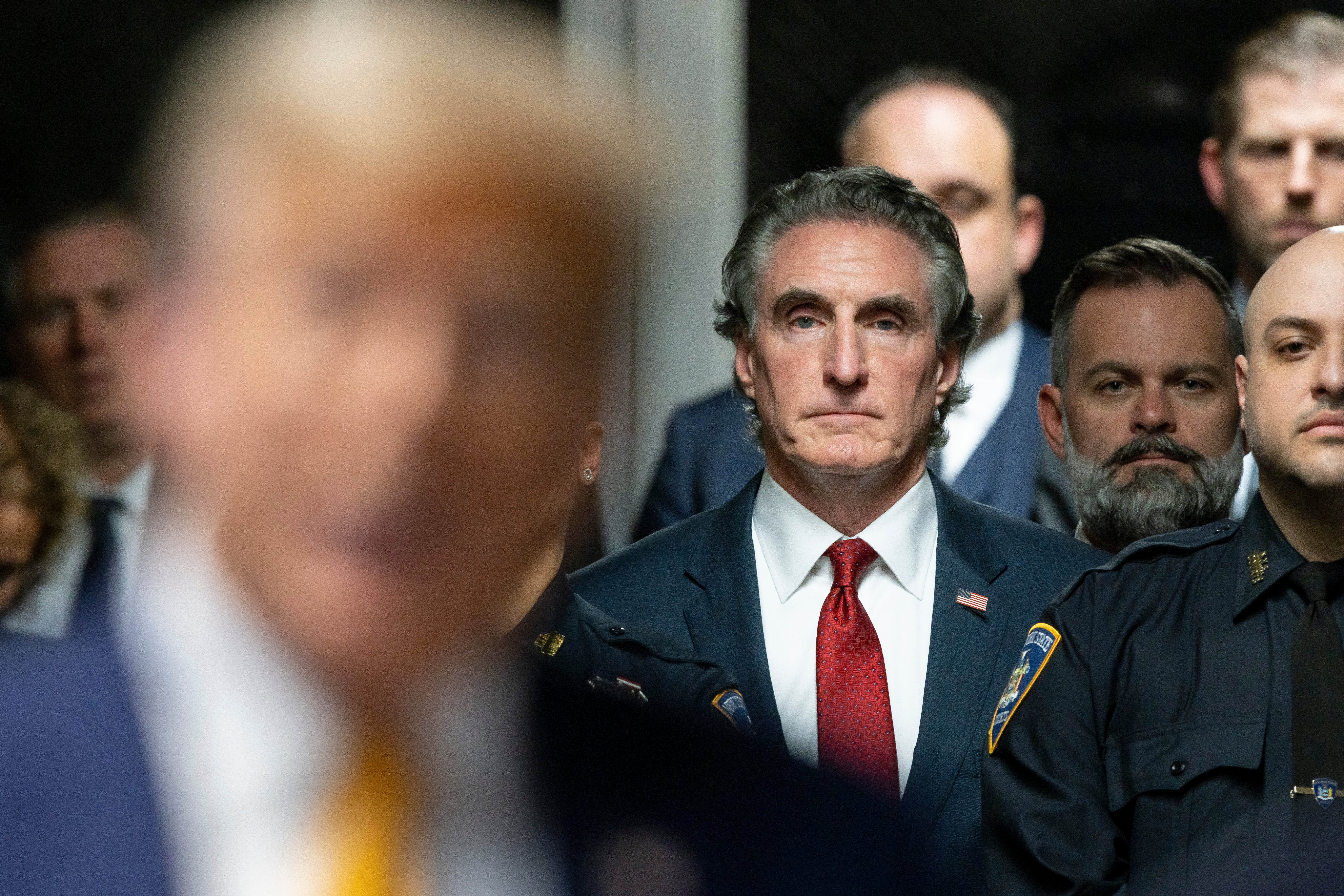 Governor Doug Burgum of North Dakota listens as former US President Donald Trump speaks to reporters at the end of the day’s proceedings in his criminal trial for allegedly covering up hush money payments at Manhattan Criminal Court on May 14, 2024