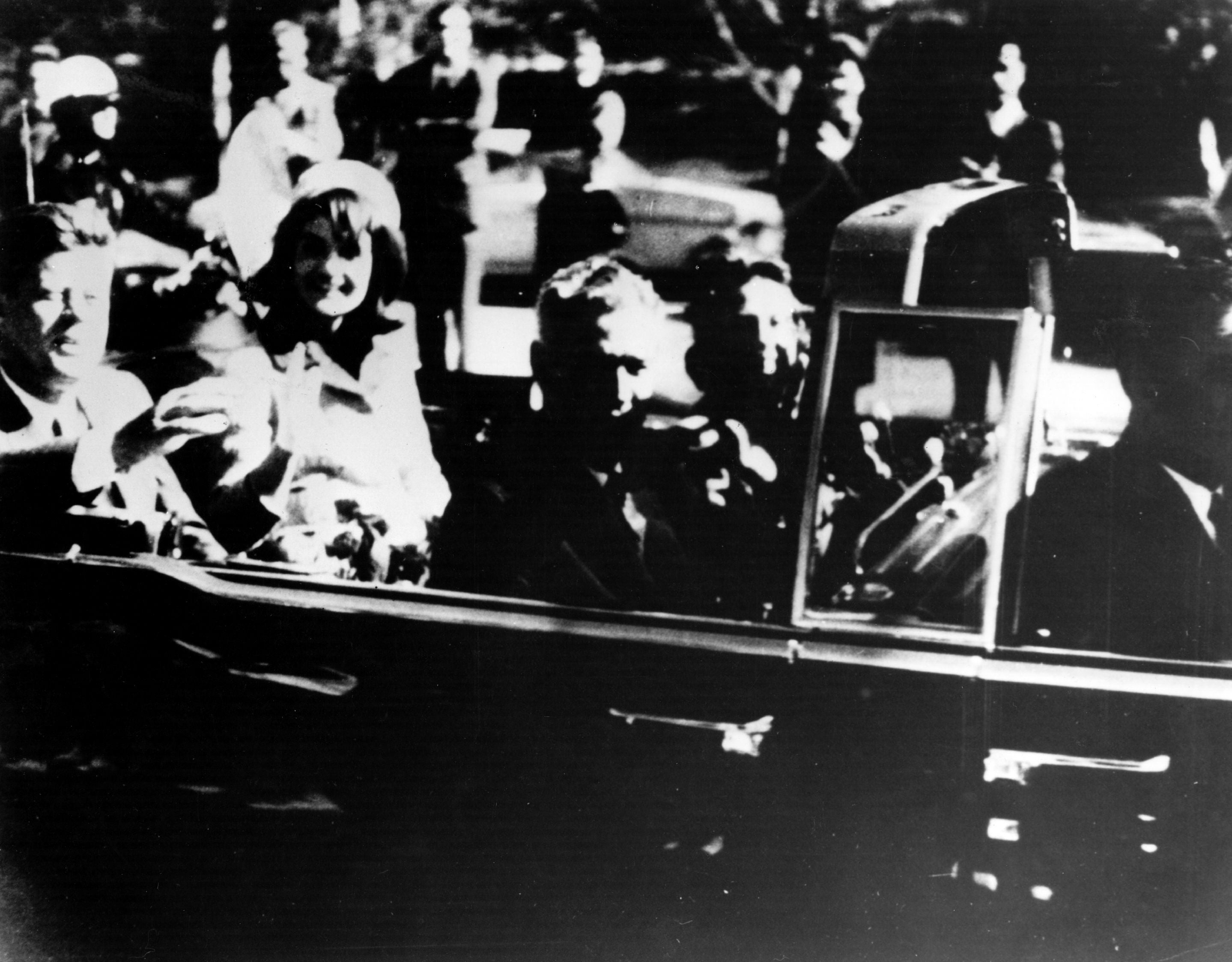 President John F Kennedy and first lady Jacqueline Kennedy in an open car motorcade shortly before he was assassinated in Dallas, Texas