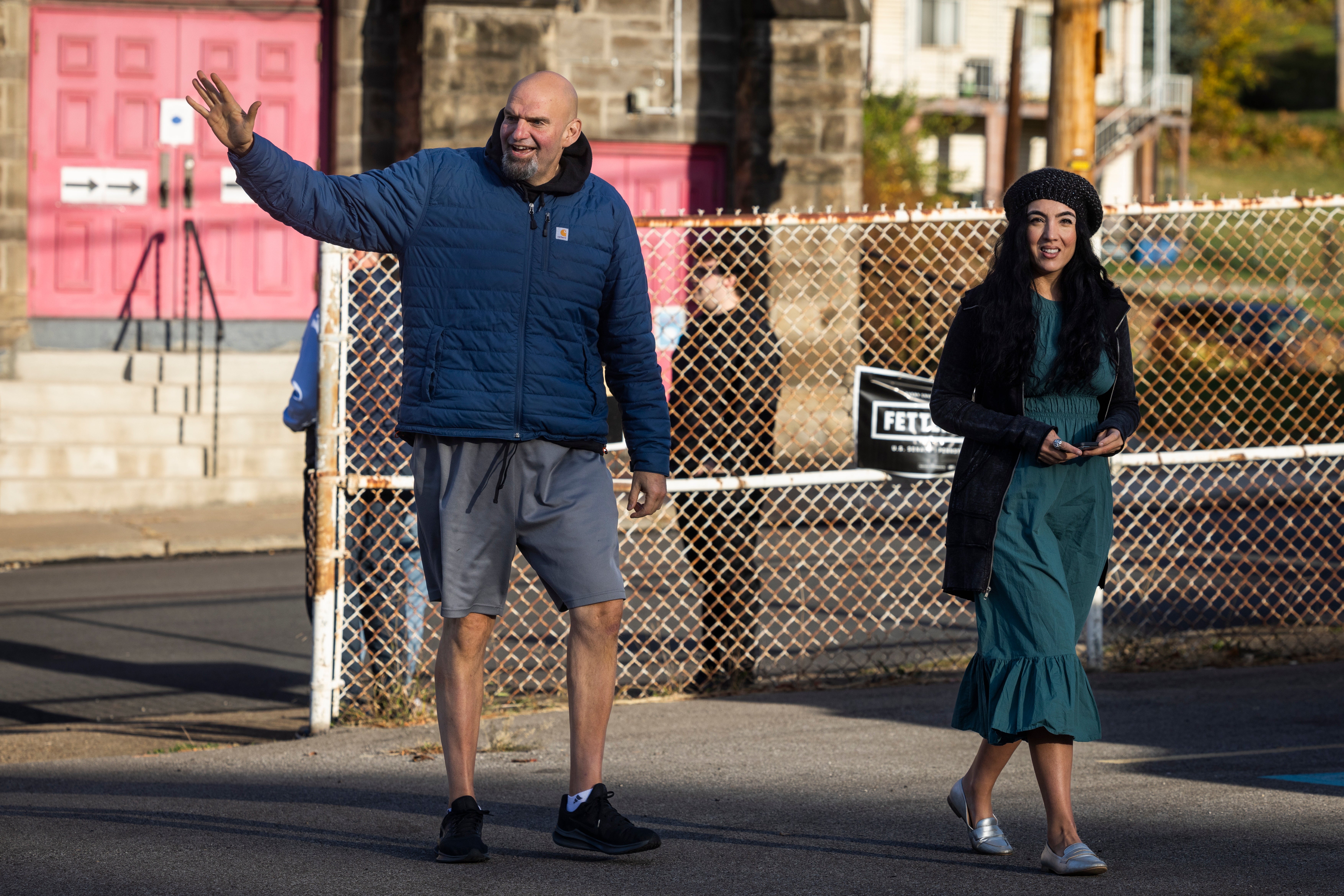 Democratic Senate candidate for Pennsylvania John Fetterman alongside his wife Gisele Barreto Fetterman (R), arrives to vote at the New Hope Baptist Church in Braddock, Pennsylvania, in November 2022