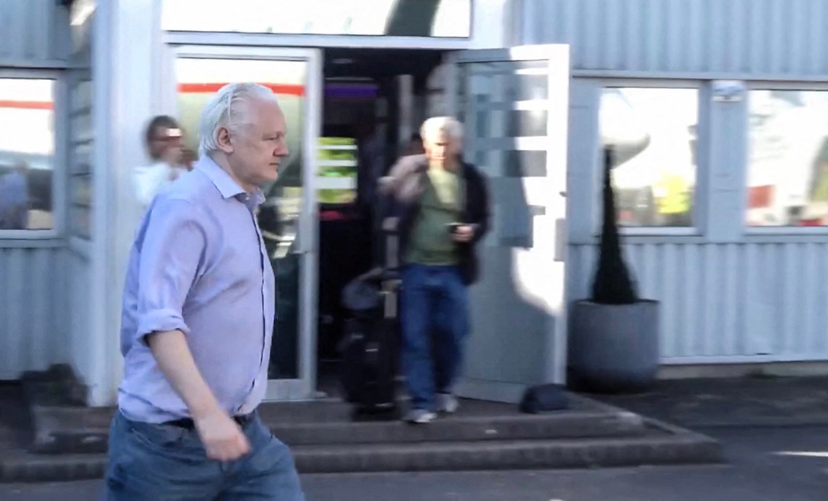 This screen shot courtesy of Wikileaks X page shows Wikileaks founder Julian Assange walking to board a plane from London Stansted Airport