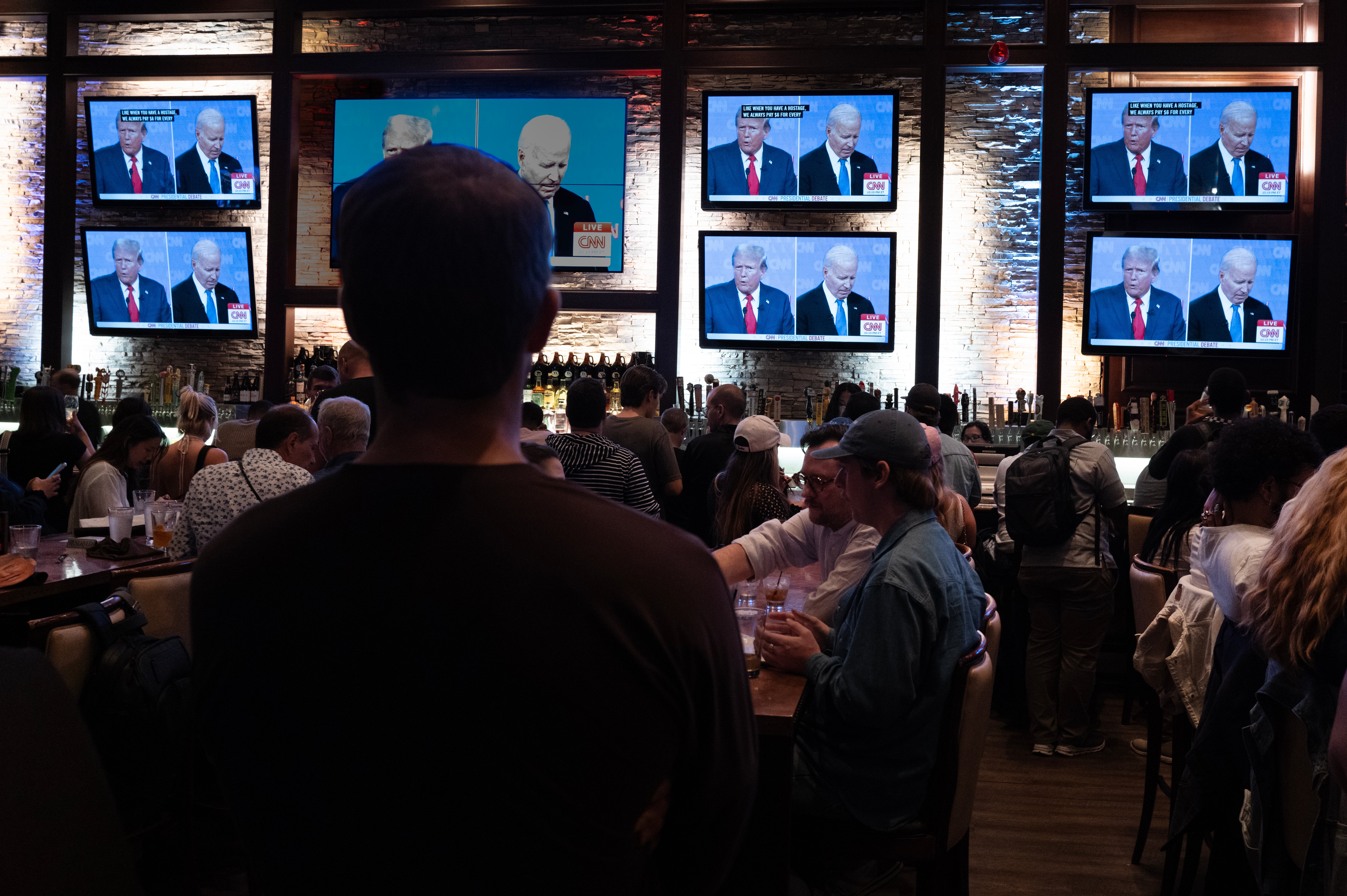Many viewers took to social media to voice their disappointment around the debate’s handling by CNN. Pictured: Customers at the Old Town Pour House in Chicago watch the debate