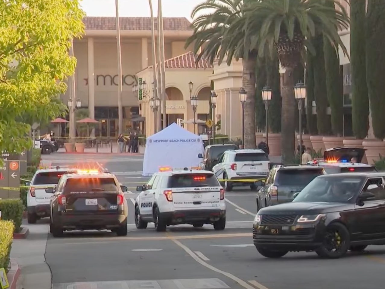 Newport Beach police block access to a street where a 68-year-old woman from New Zealand was killed after she was hit by a car driven by suspects who tried to rob her at the Fashion Island mall in July 2024