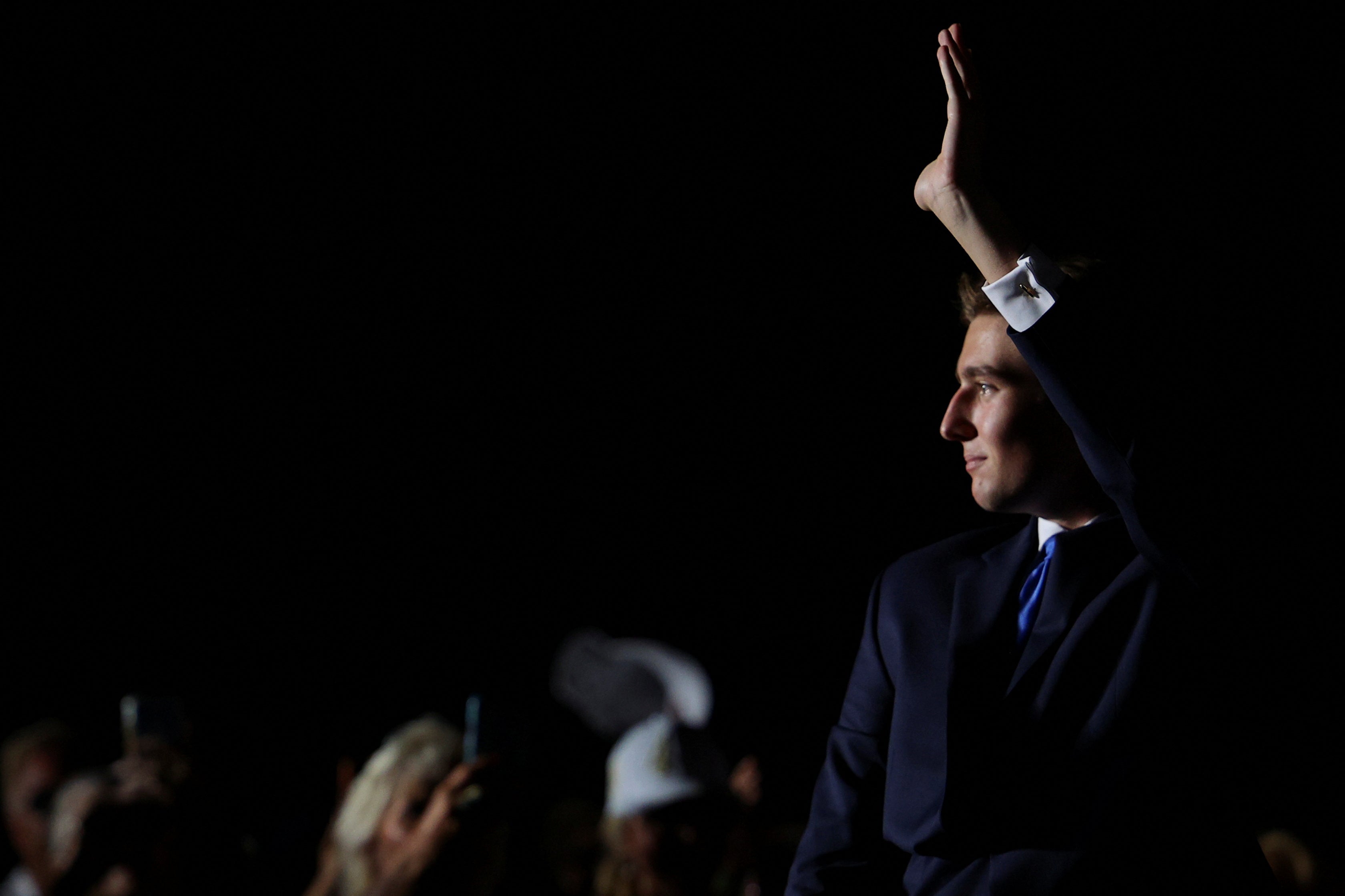 Barron Trump waves to a crowd at his father’s Doral resort in Miami on July 9.