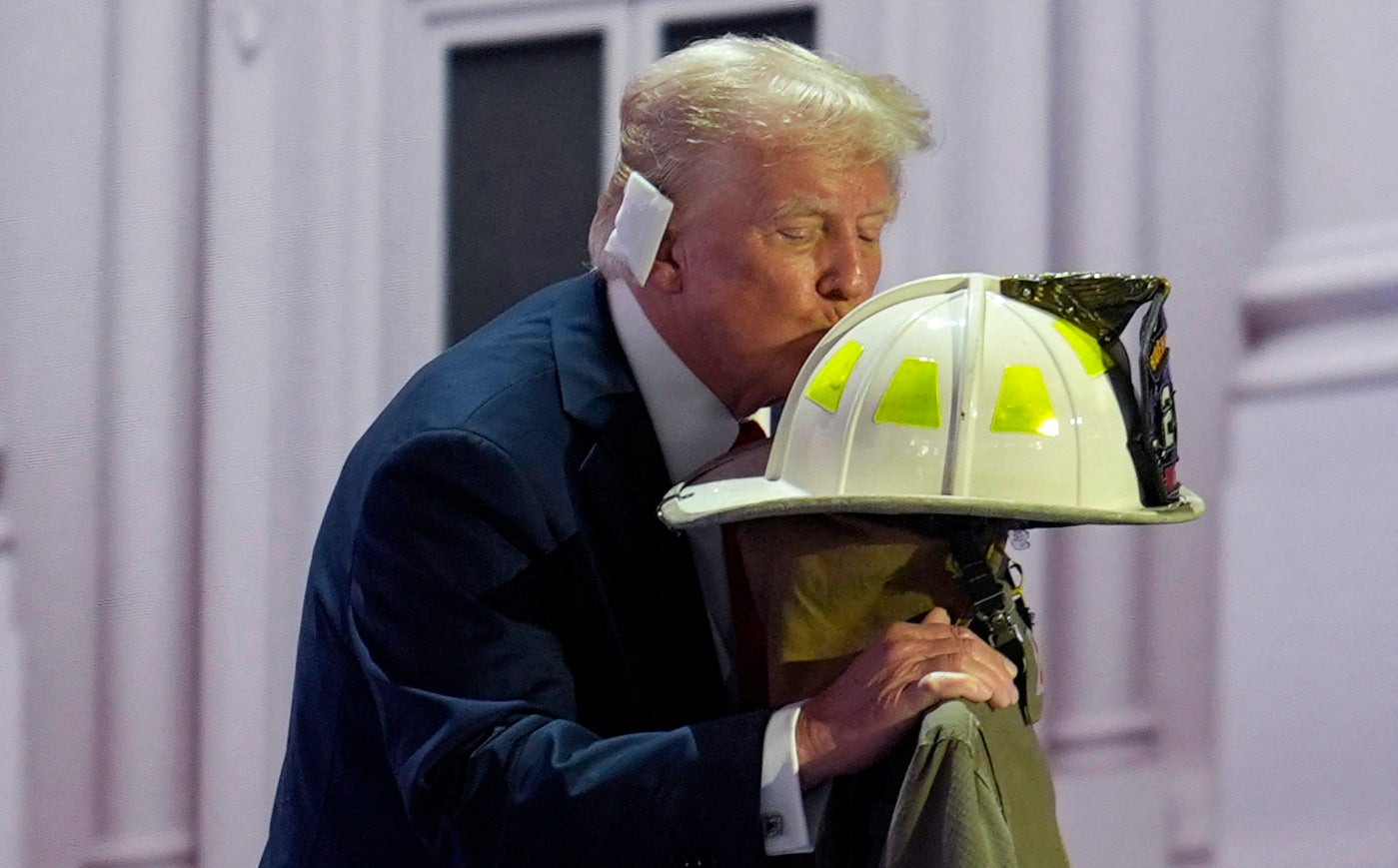 Donald Trump kisses the helmet of former Buffalo Township Volunteer Fire Department chief Corey Comperatore, who was killed at the former president’s campaign rally in Pennsylvania last Saturday