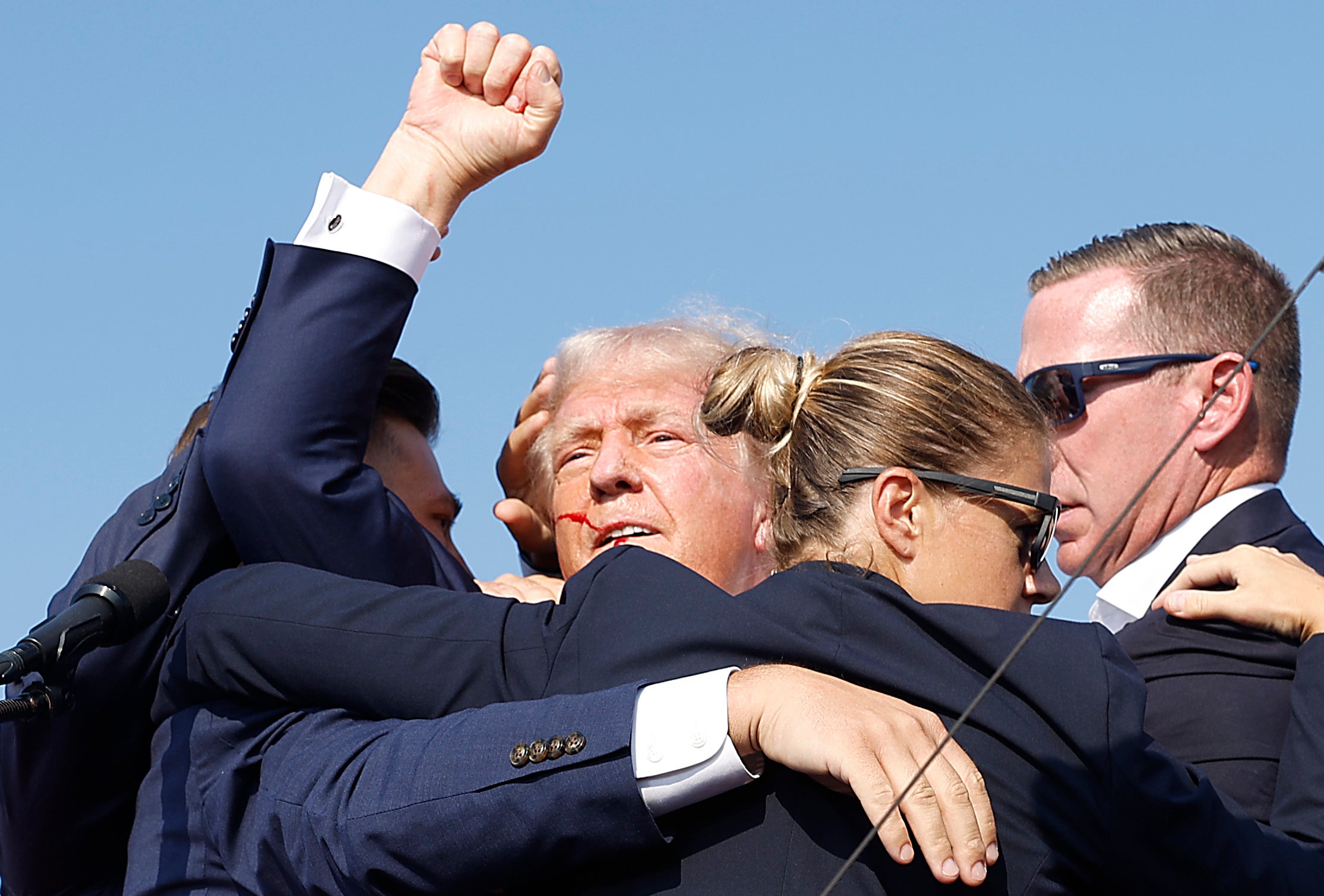 Secret Service agents rush Donald Trump off a rally stage after he survived an assassination attempt on July 13. The agency has rejected false claims that his campaign was denied additional protections.