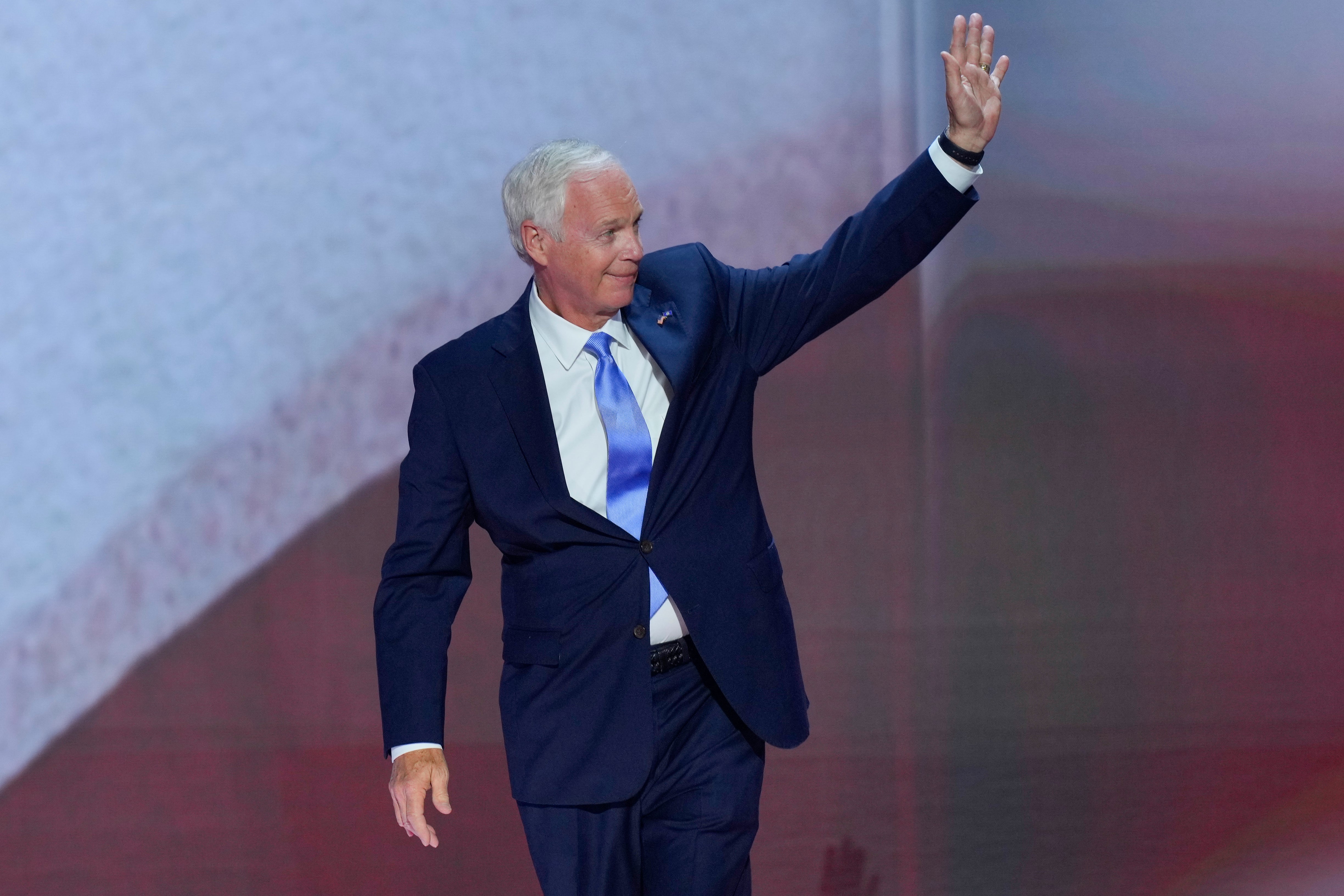 Senator Ron Johnson waves to the crowd as he is introduced during the first day at the Republican National Convention