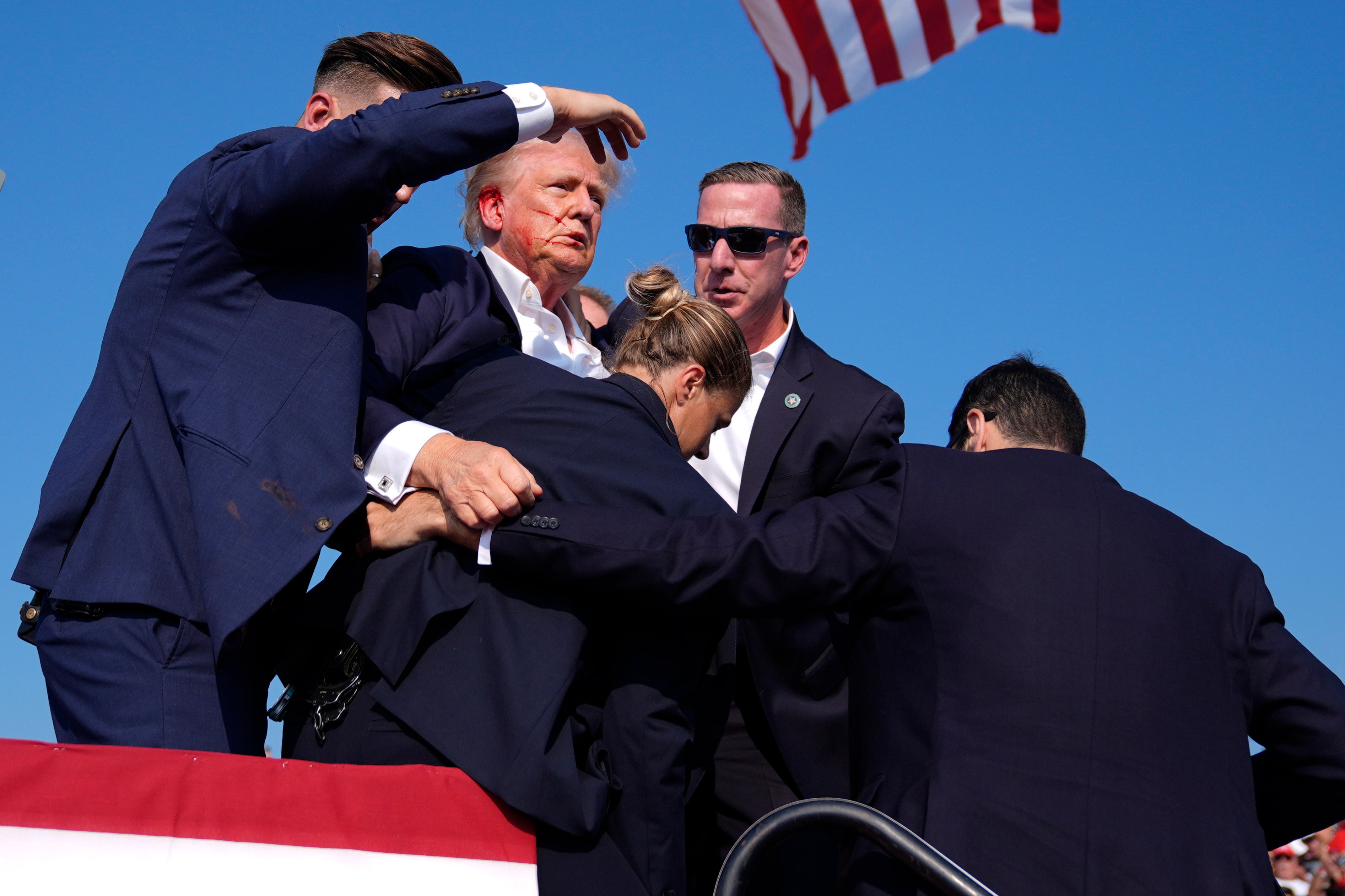 Donald Trump is surround by Secret Service agents after he was shot at a campaign rally in Butler, Pennsylvania on July 13. On July 26, he said he plans to hold another rally in the town.