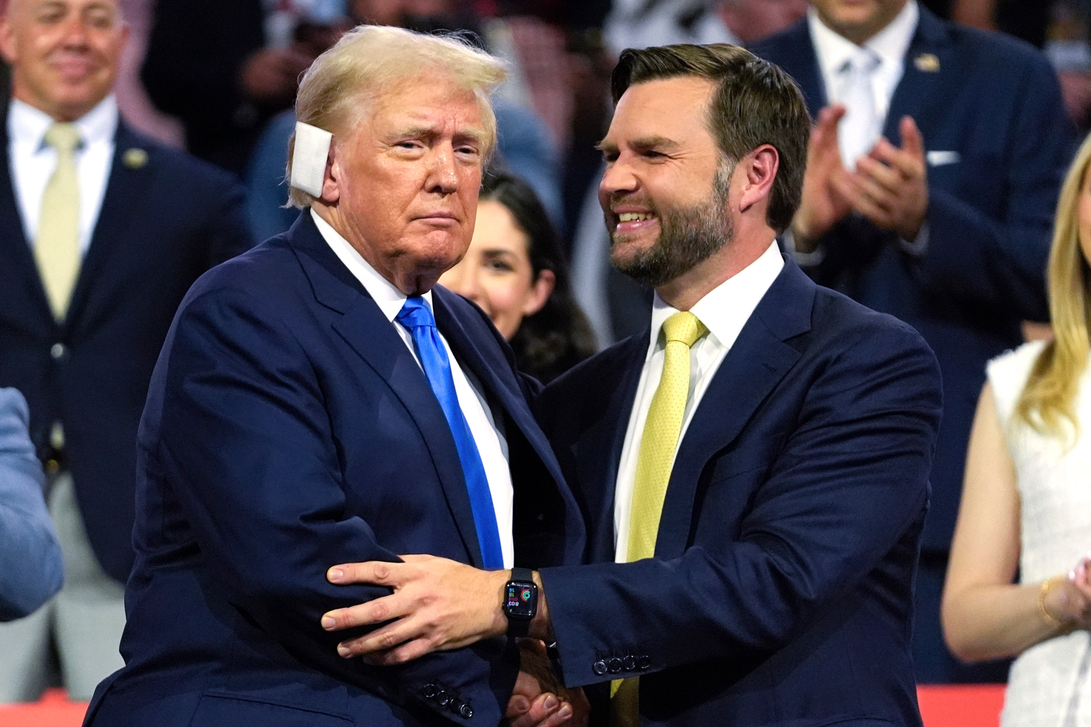 JD Vance shakes hands with Donald Trump, his running mate for the 2024 election, at the RNC. Vance’s far-right views have become a drag for Trump in polling since his selection as vice presidential nominee.