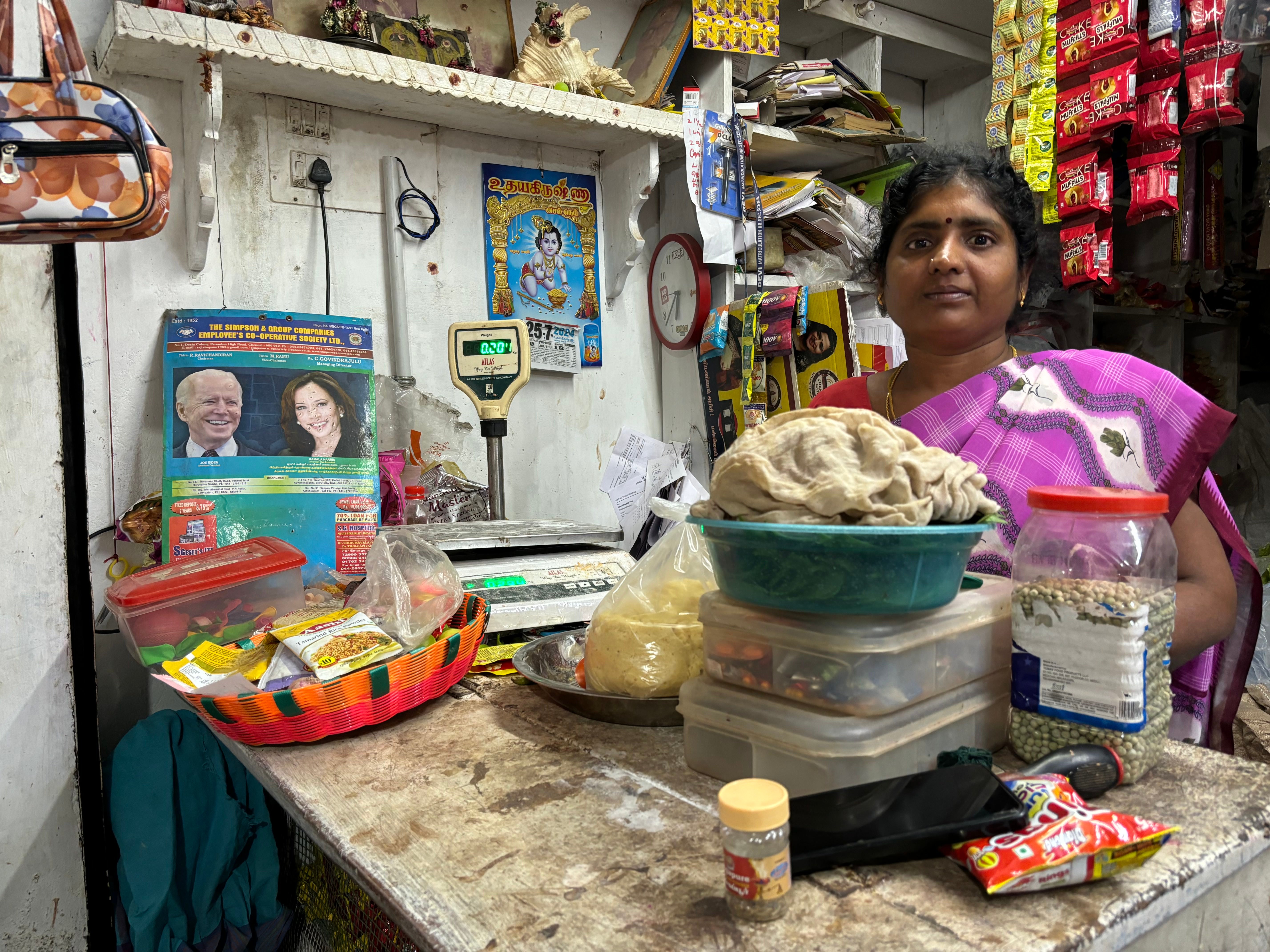 Local resident and grocery shopkeeper Maheshwari with Biden-Harris calendar