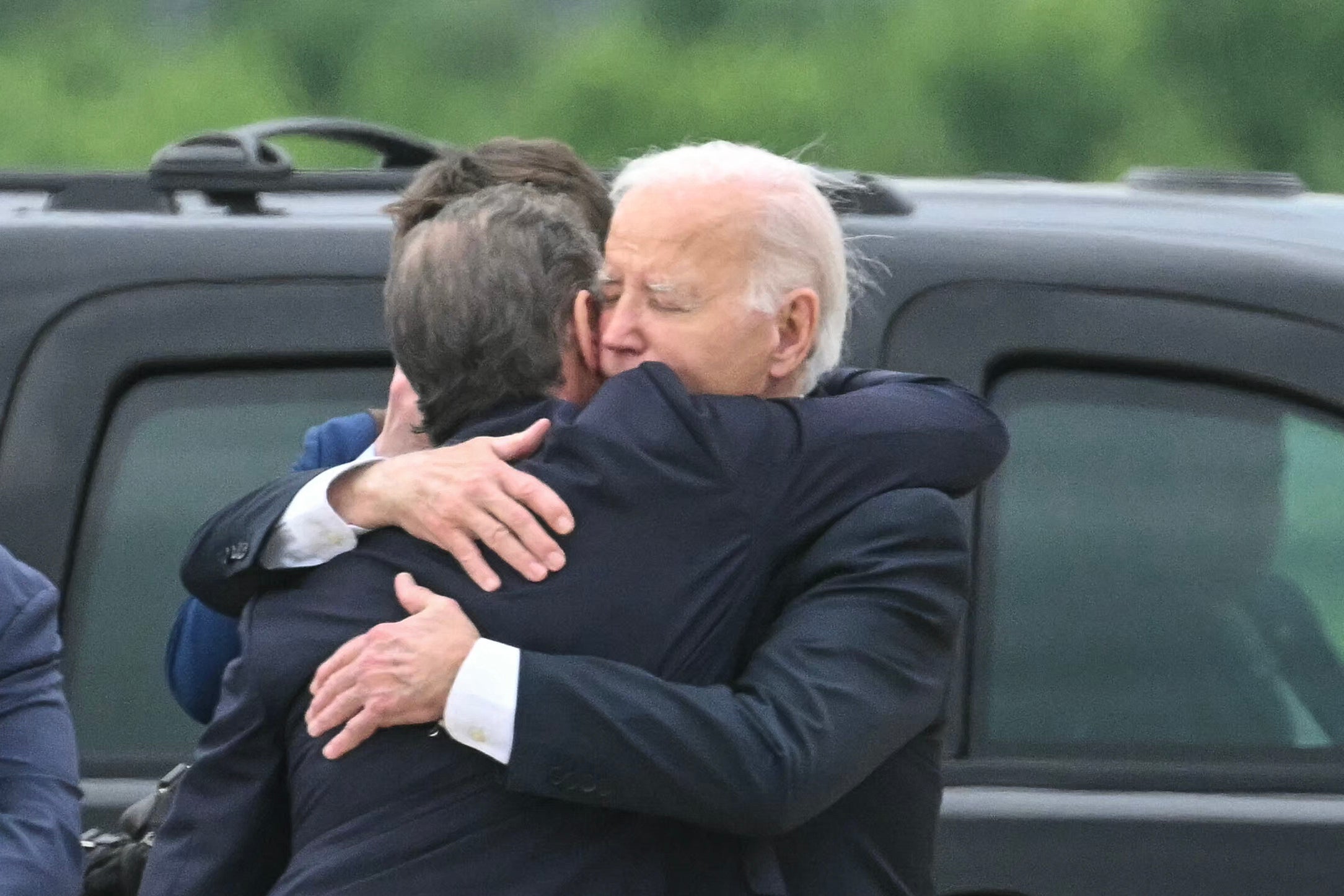 US President Joe Biden hugs his son Hunter Biden upon arrival at Delaware Air National Guard Base in New Castle, Delaware, on June 11