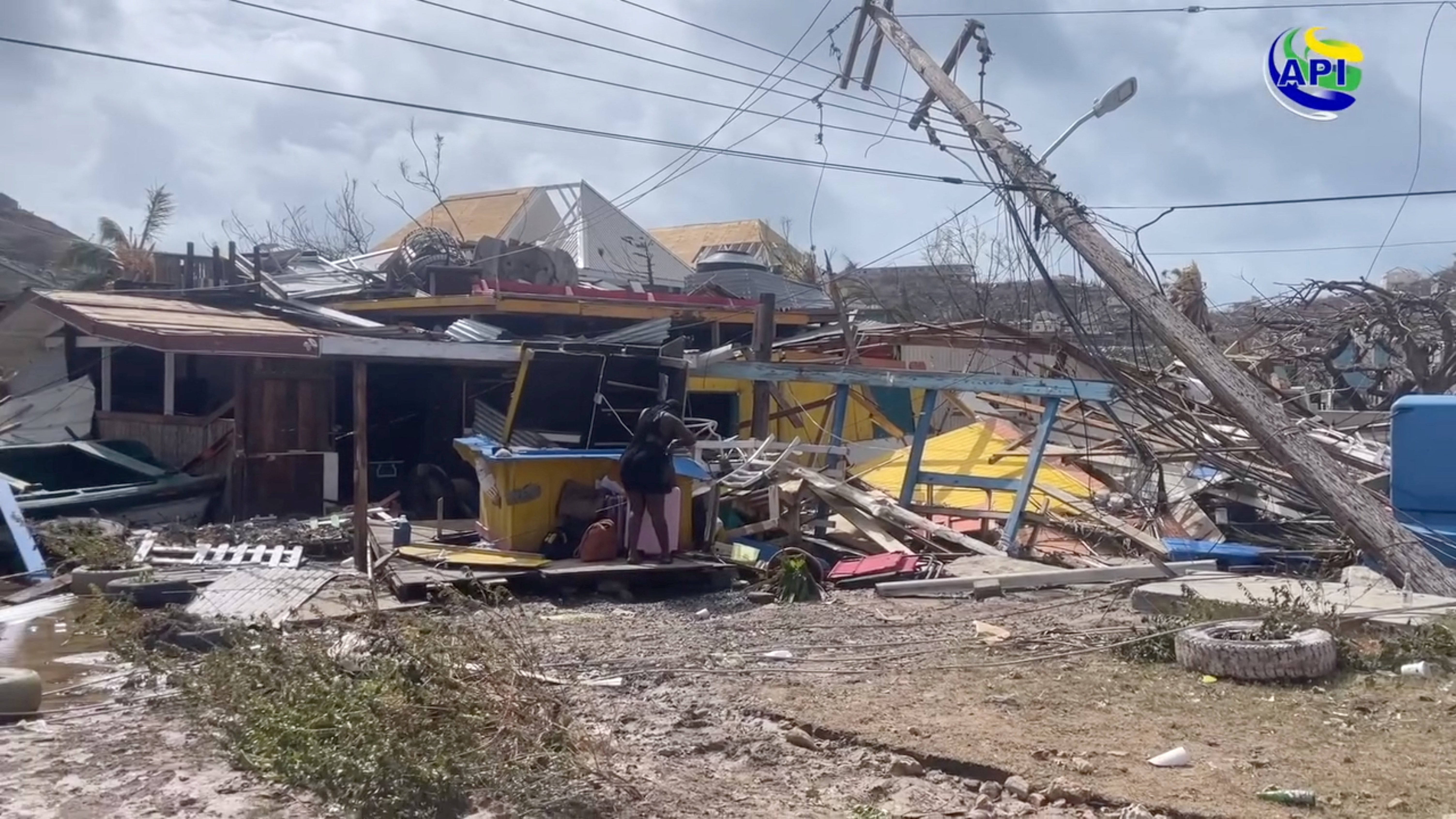 A person stands among debris in Union Island, Saint Vincent and the Grenadine after Hurricane Beryl