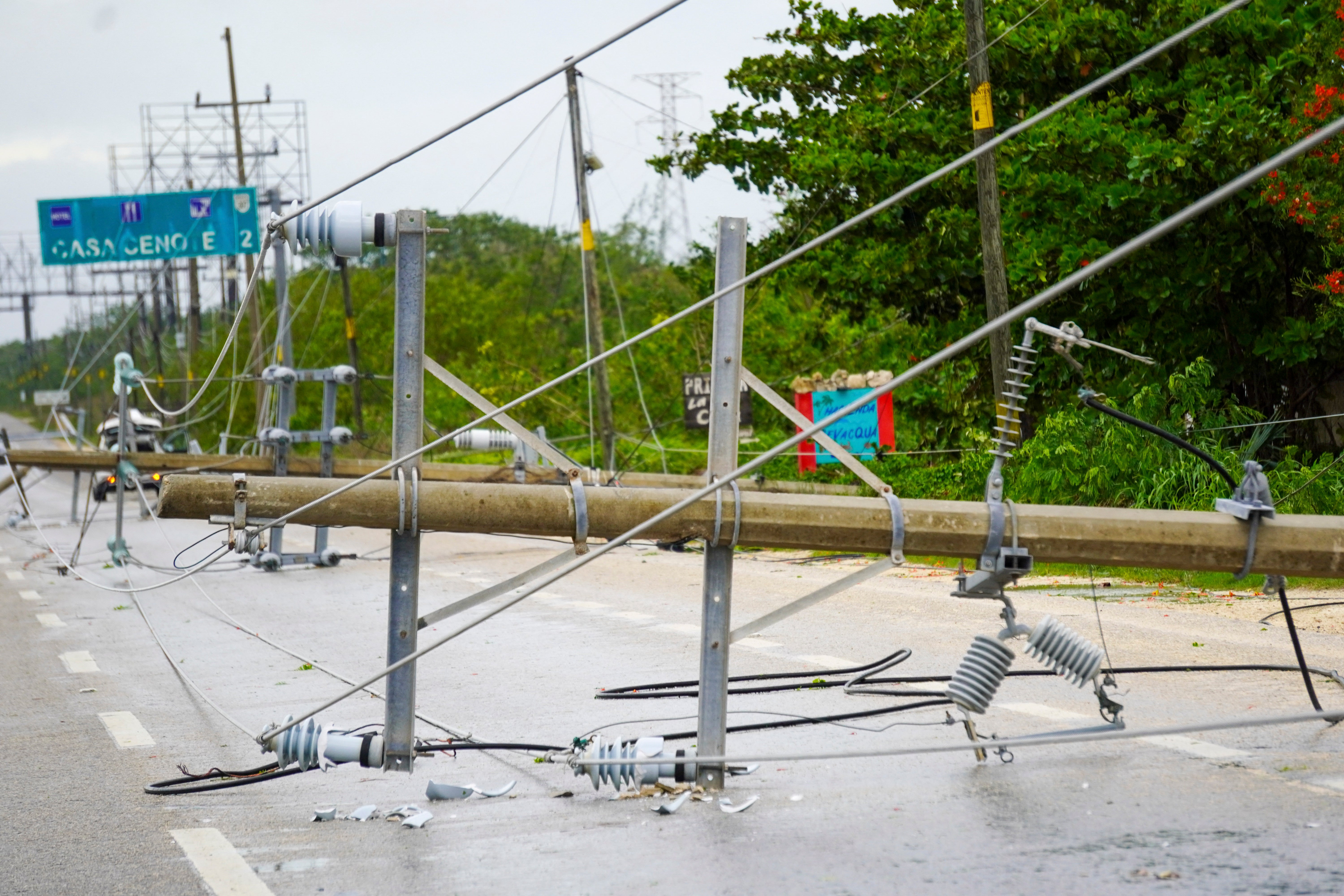 Power lines lie on a road in Tulum, Mexico after Hurricane Beryl on Friday