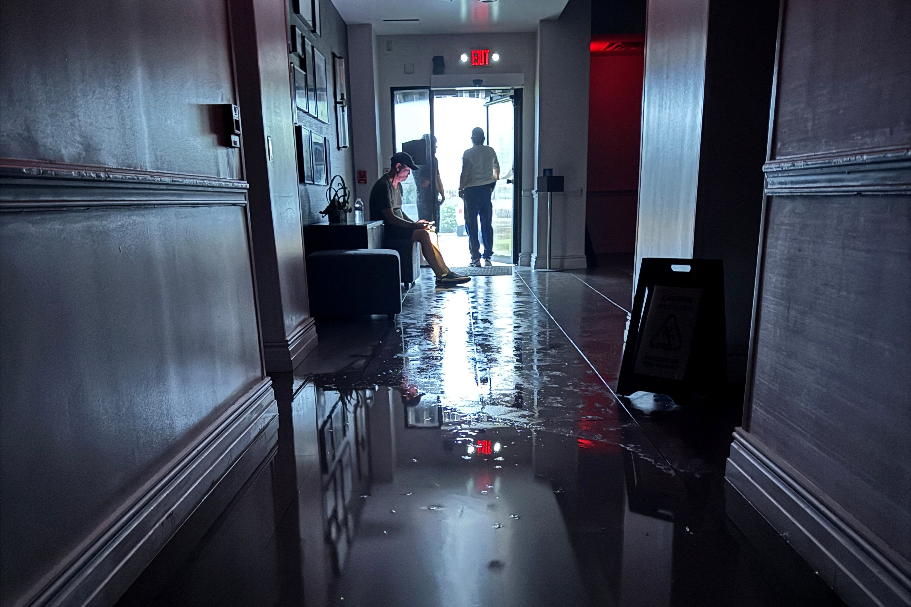 Hotel guests at the Hilton Galveston resort look out the back door of the hotel watching the storm as Hurricane Beryl arrived in Galveston, Texas, U.S. July 8, 2024