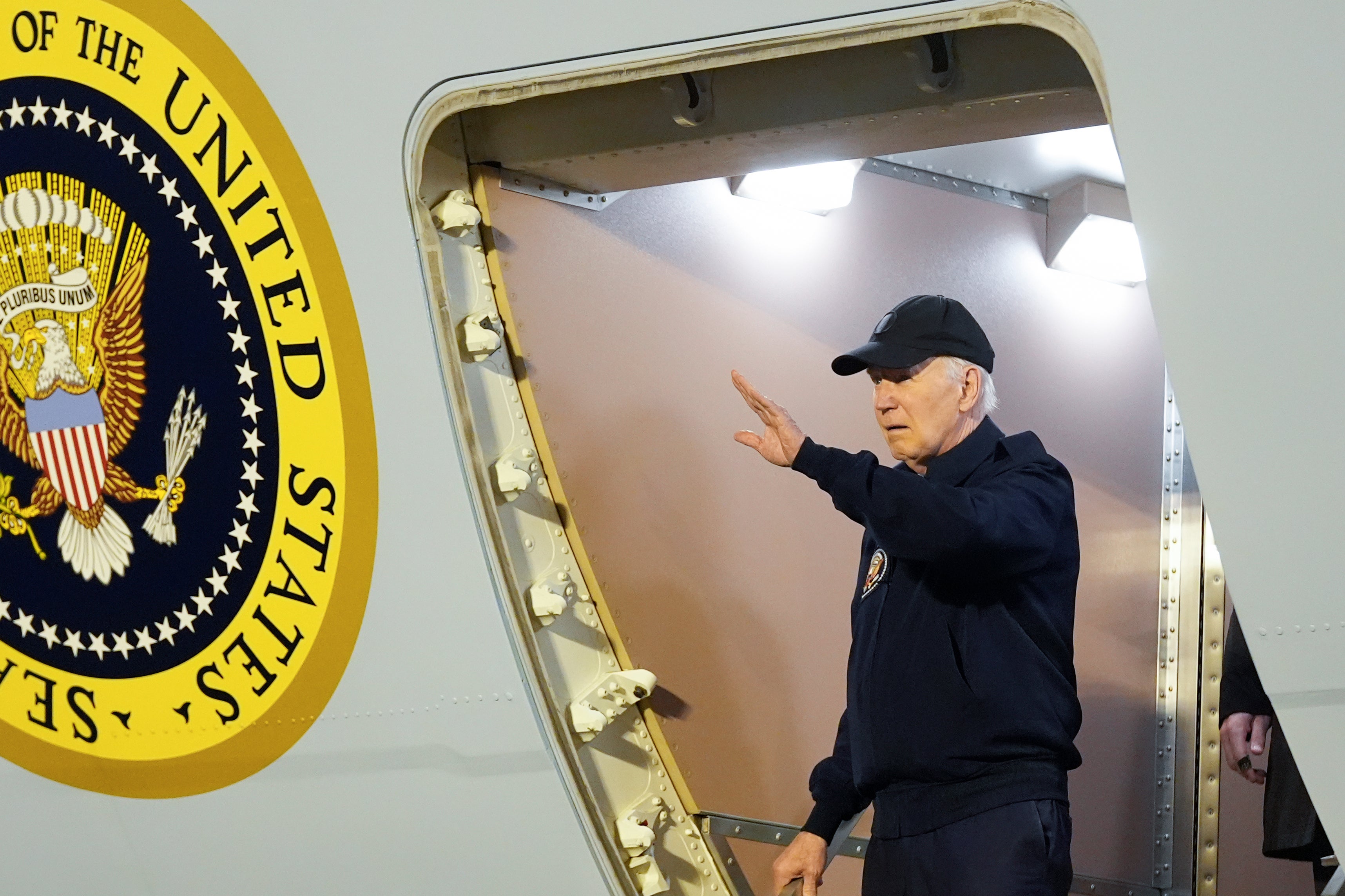 Joe Biden waves as he walks down the steps of Air Force One at Dover Air Force Base in Delaware on Wednesday