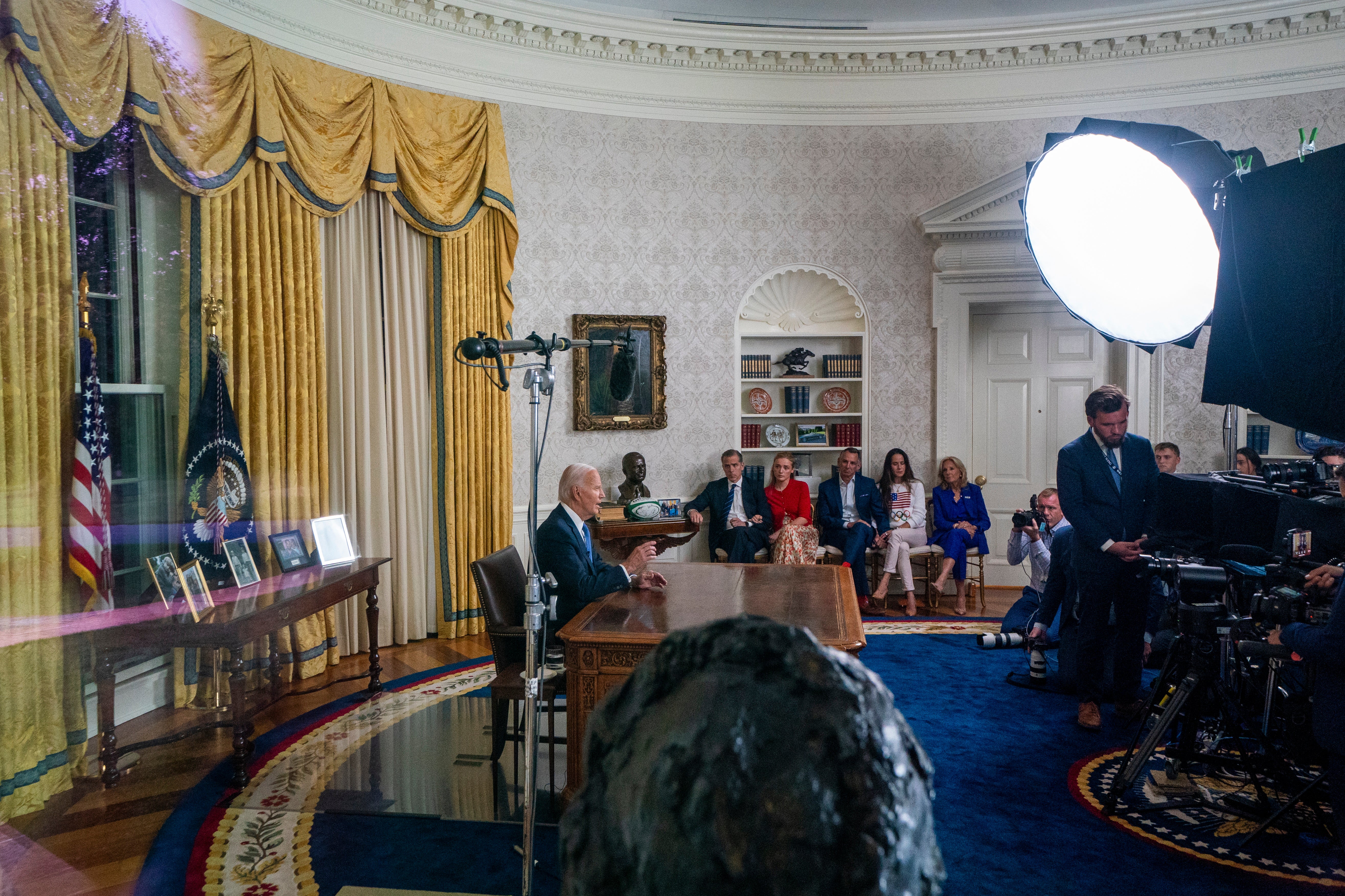 President Joe Biden with family members nearby as he delivers remarks during an address from the Oval Office of the White House