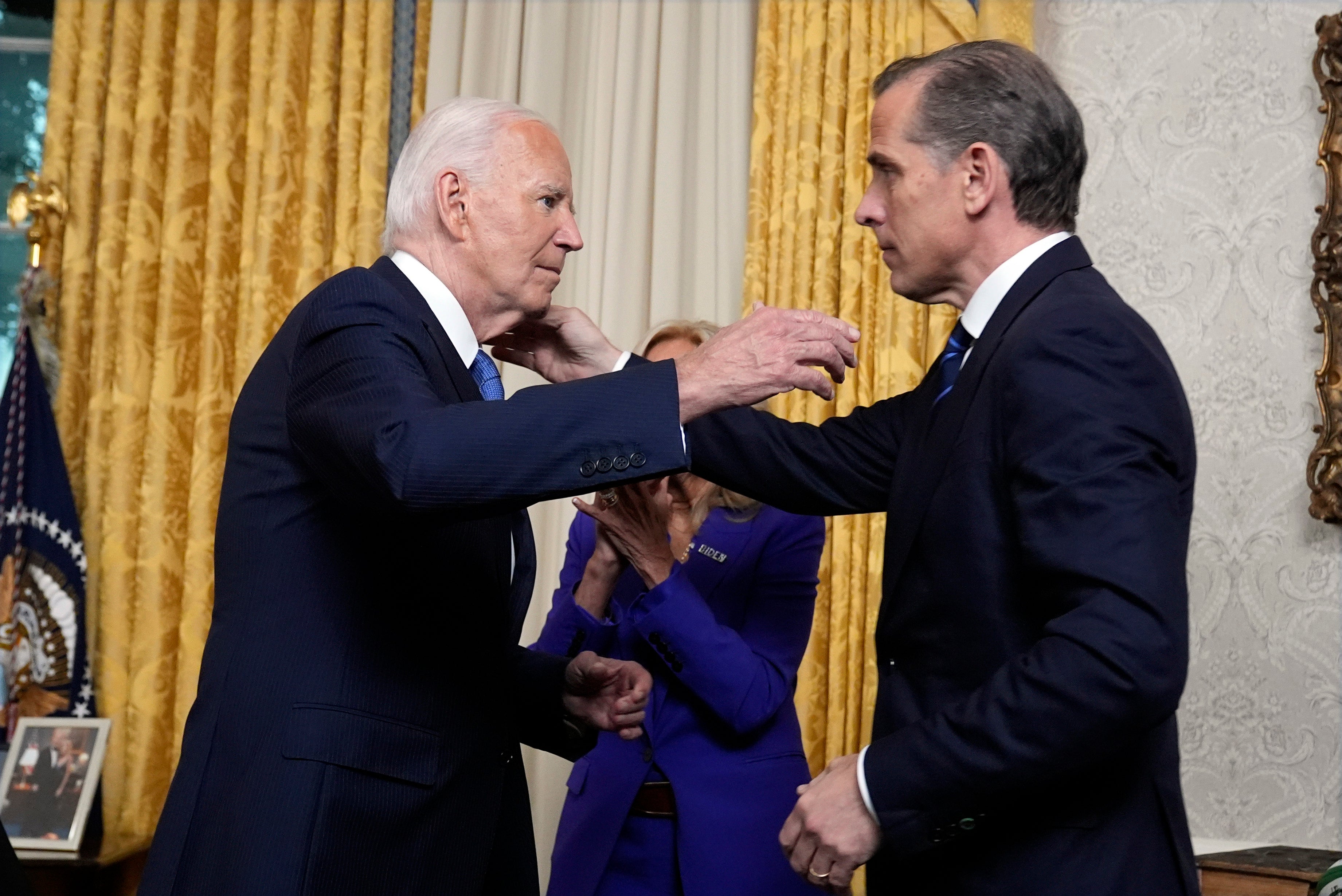 US President Joe Biden hugs son Hunter Biden after addressing the nation from the Oval Office of the White House in Washington, DC