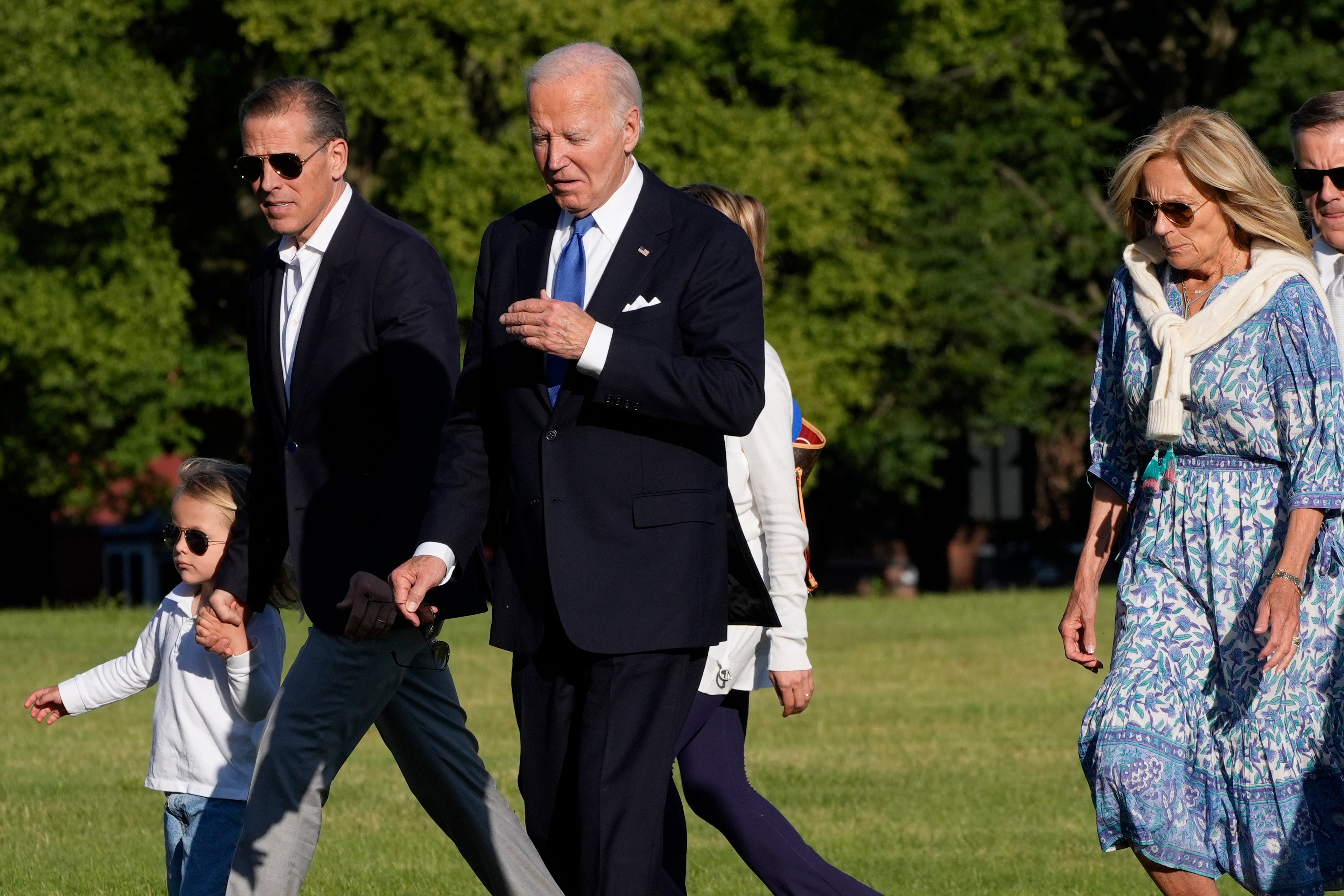 Joe Biden, beset by Democrats calling for him to drop out, walks with family members including Hunter Biden