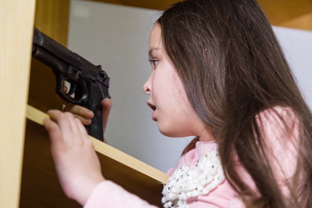 Young girl finds gun in closet to illustrate Teaching Kids About Guns and Gun Safety and gun safety course for youth