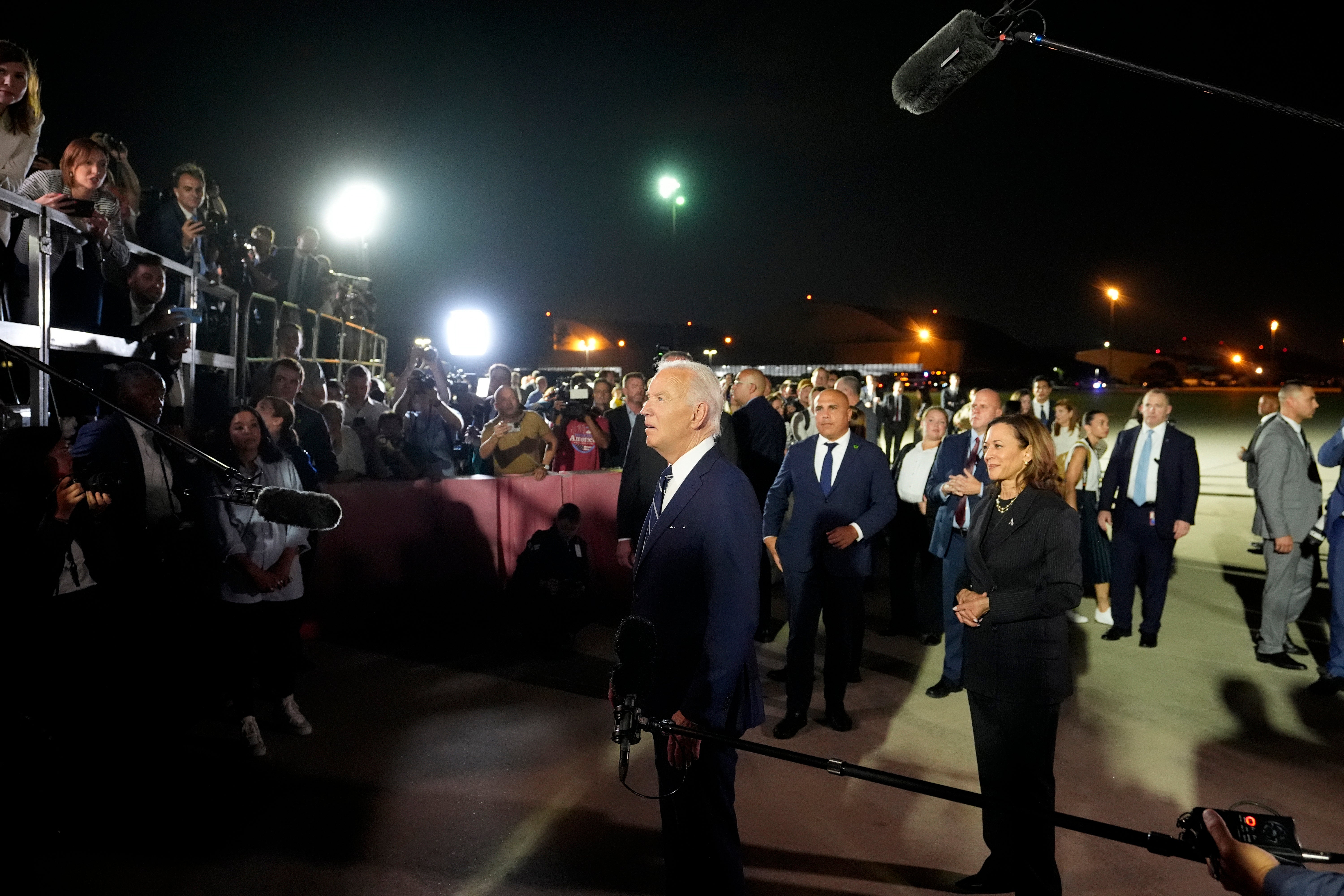 President Joe Biden, left, and vice president Kamala Harris, right, speak with reporters after greeting reporter Evan Gershkovich, Alsu Kurmasheva and Paul Whelan at Andrews Air Force Base