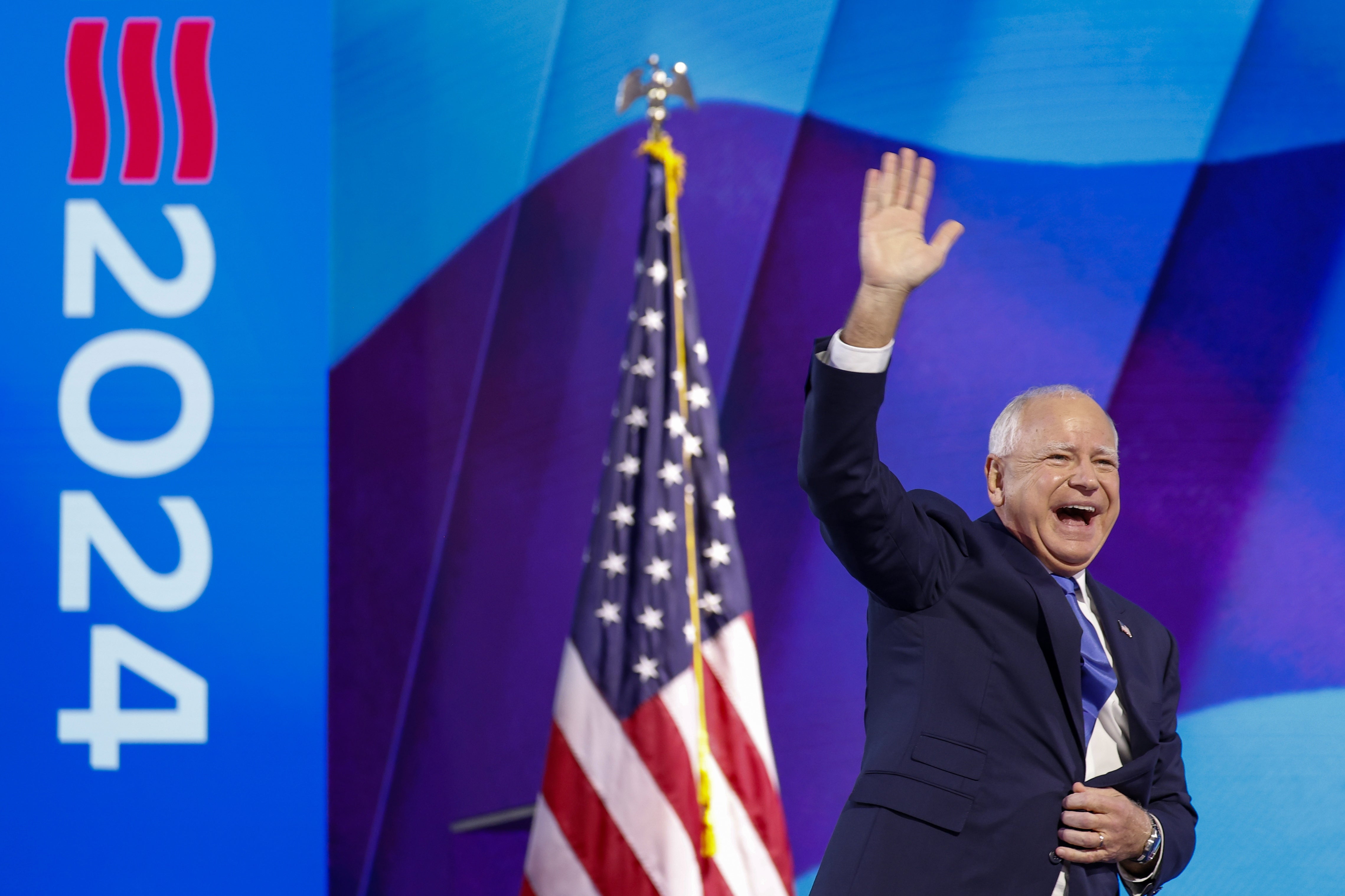 Democratic vice-presidential nominee Tim Walz walks on stage to deliver keynote speech