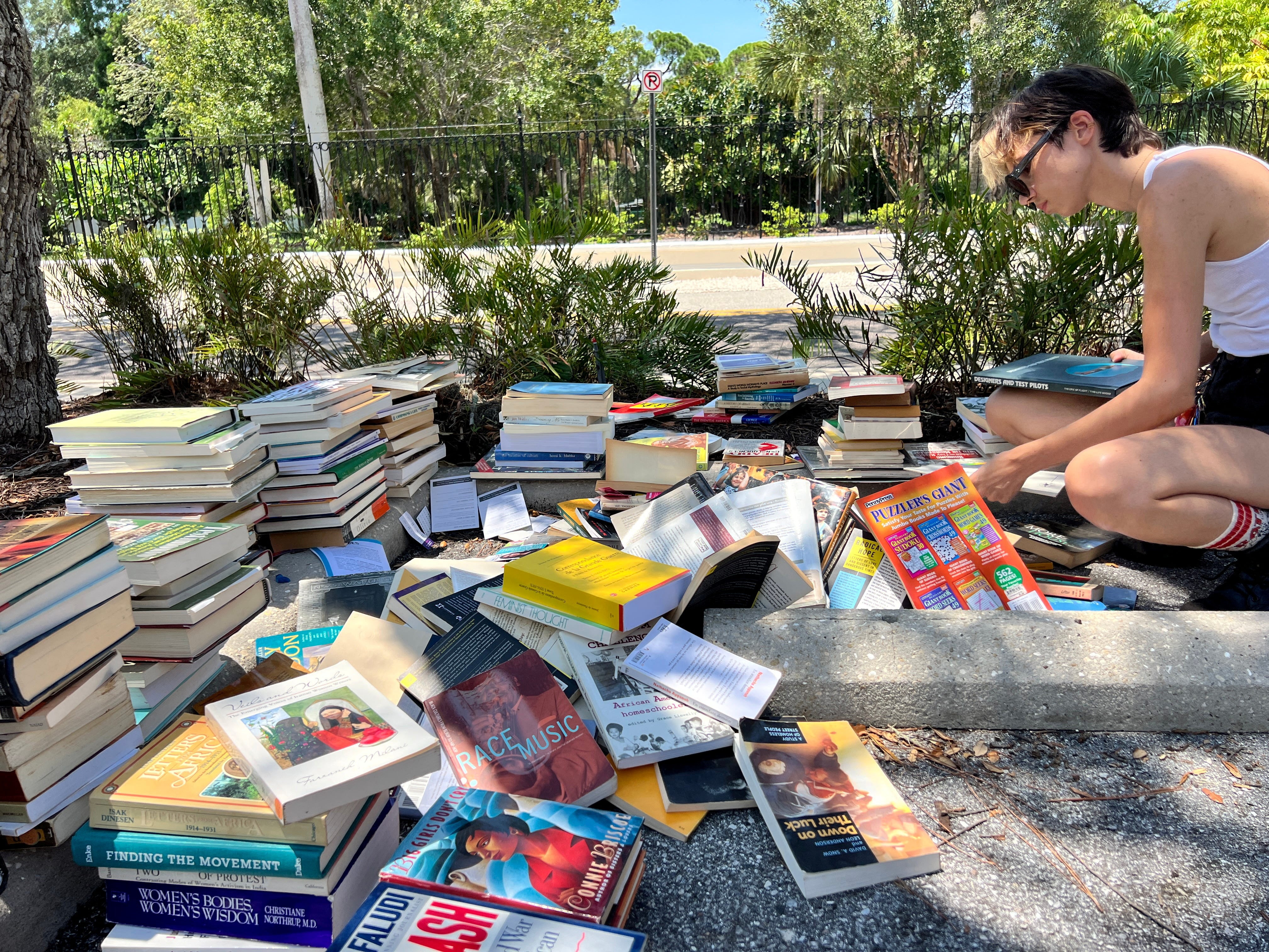 New College of Florida students, activists and alumni pick through discarded books from the school’s Gender and Diversity Center in Sarasota, Florida