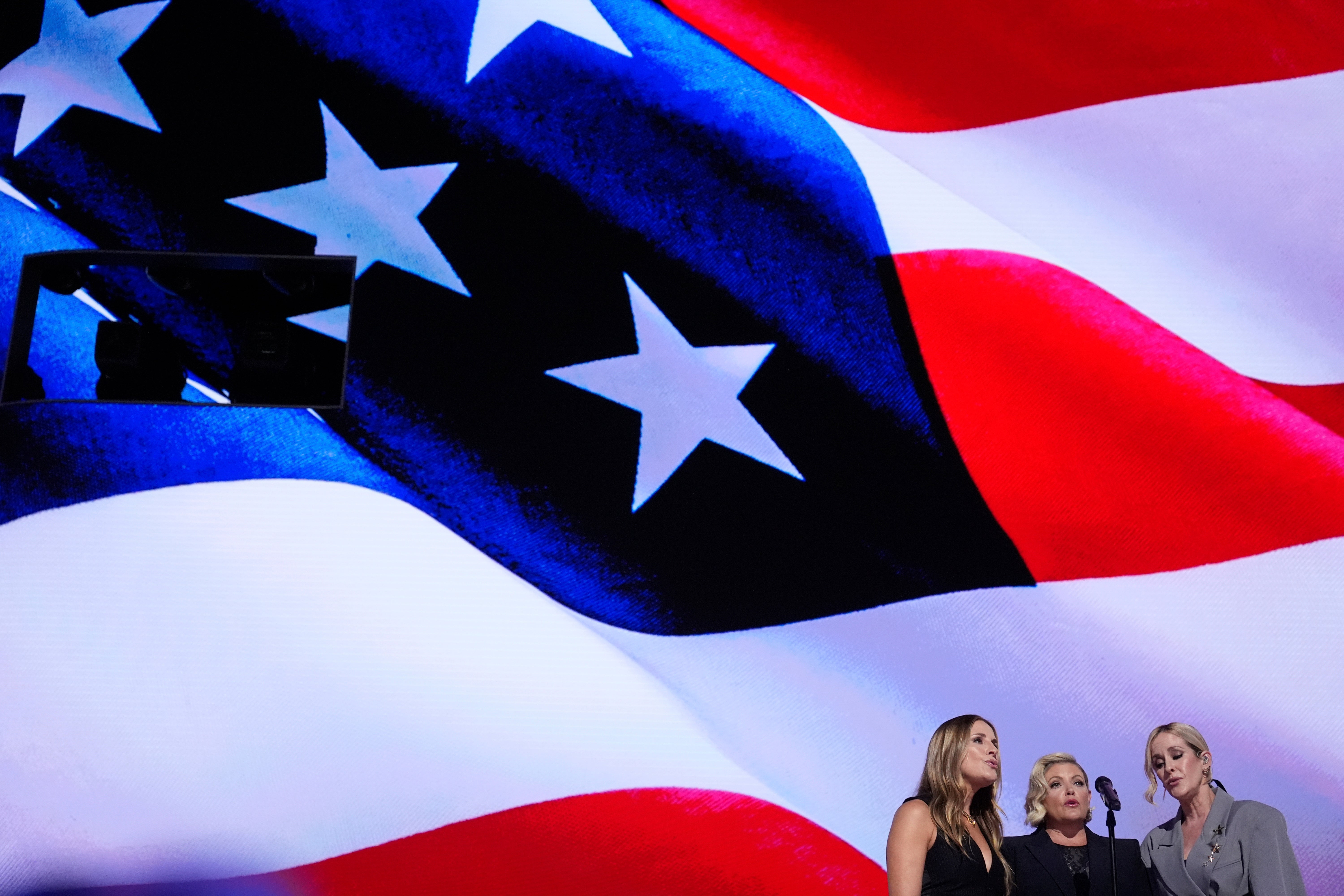 Emily Robison, from left, Natalie Maines and Martie Maguire, of The Chicks, sing the national anthem during the Democratic National Convention August 22 in Chicago