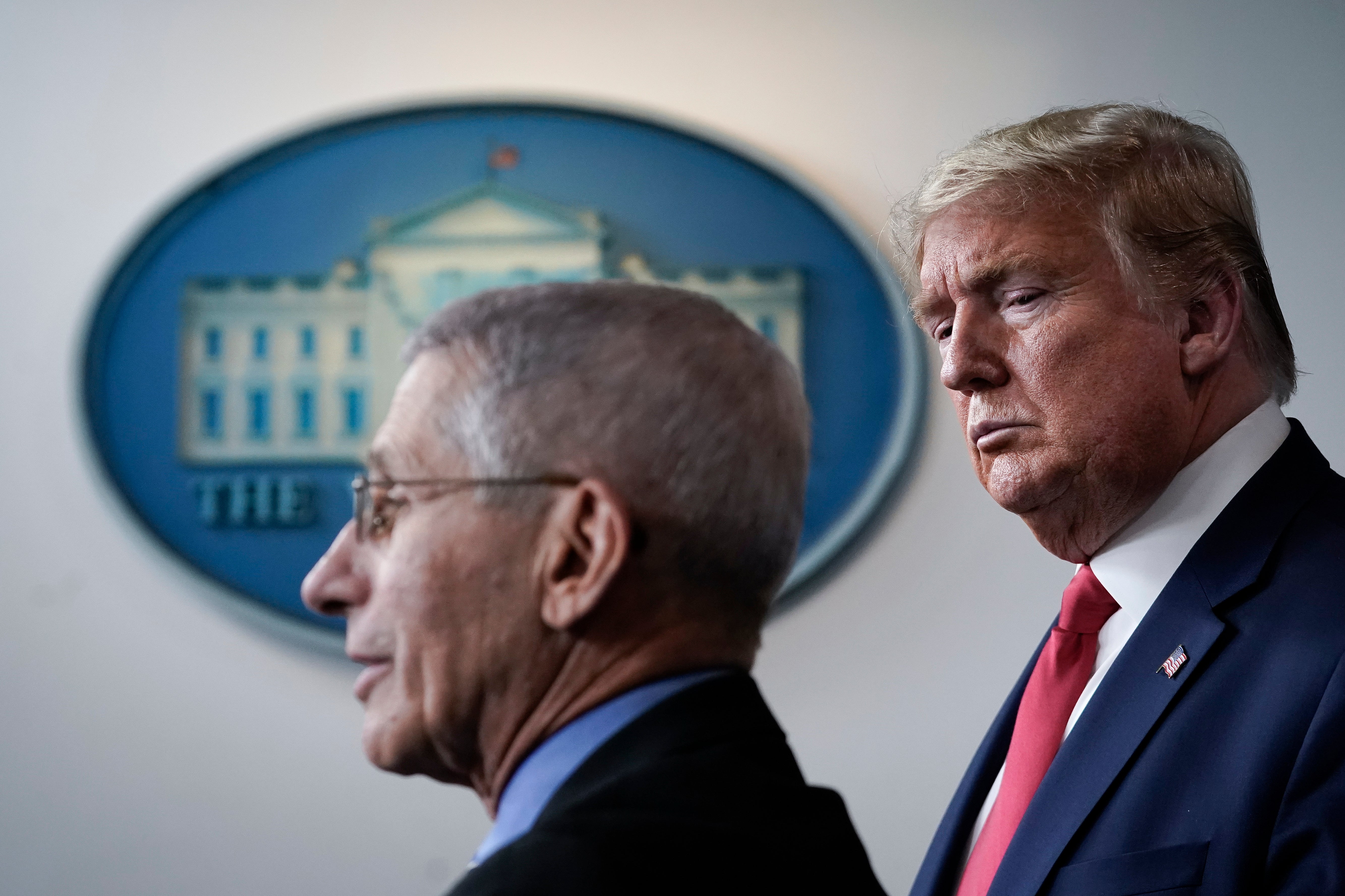 Fauci and Donald Trump stand together at a COVID-19 briefing at the White House. Fauci said that Trump went on expletive-filled rants directed at him