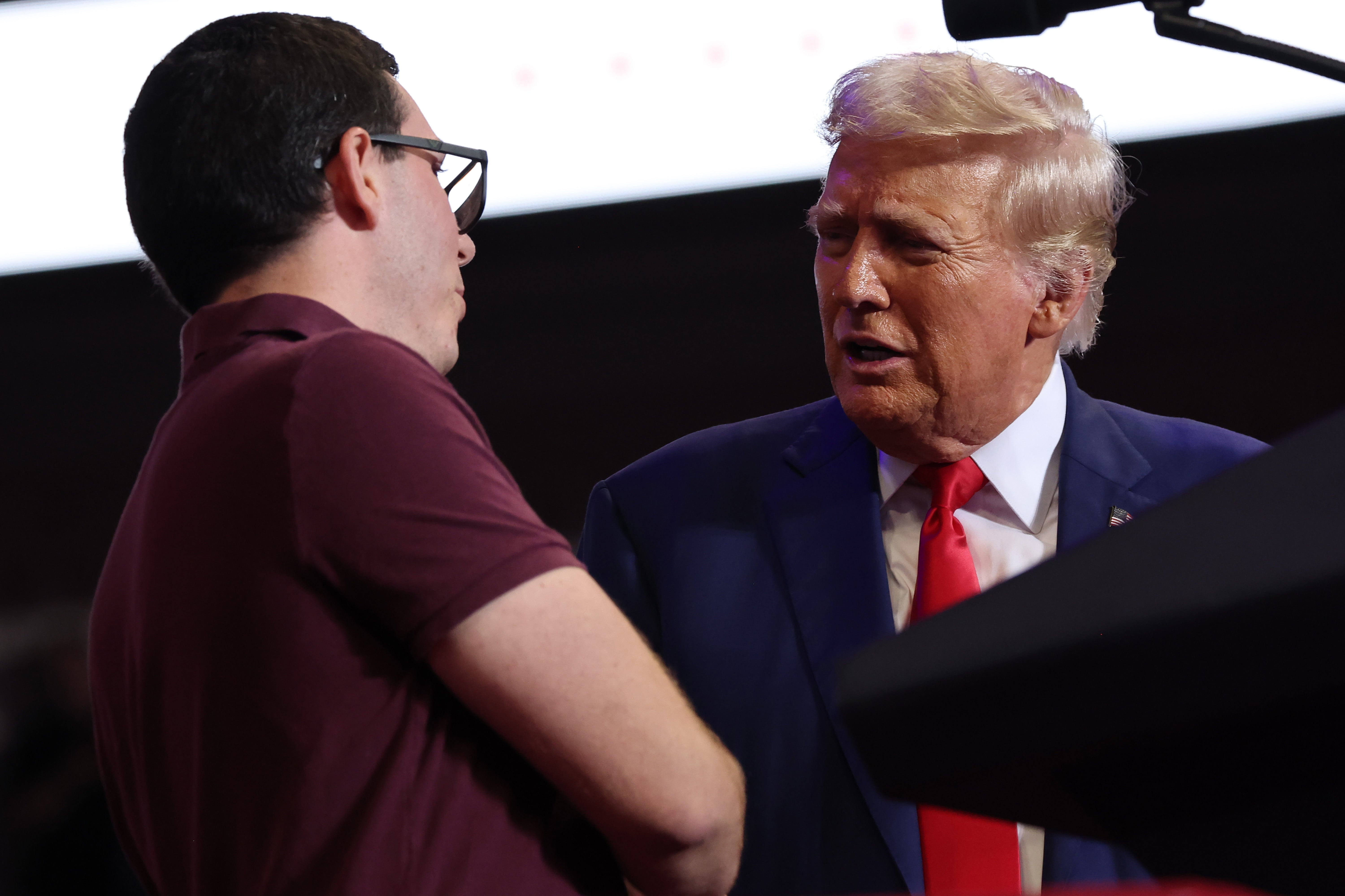 Republican Presidential Candidate former US President Donald Trump shakes hands with Daniel Campos during a campaign rally at Mohegan Sun Arena at Casey Plaza on August 17, 2024 in Wilkes Barre, Pennsylvania