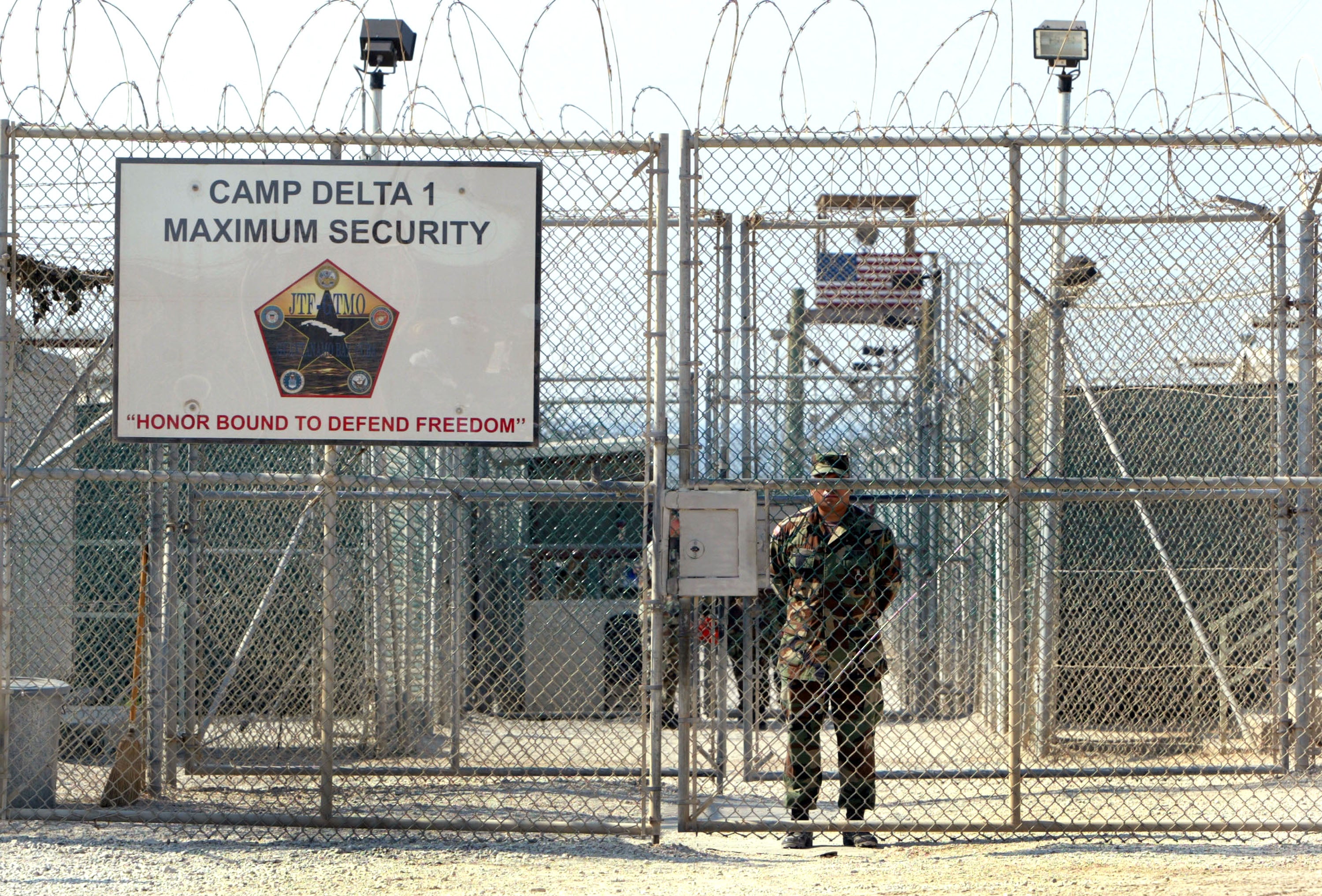 A U.S. Army soldier stands at the entrance to Camp Delta where detainees from the U.S. war in Afghanistan live April 7, 2004 in Guantanamo Bay, Cuba