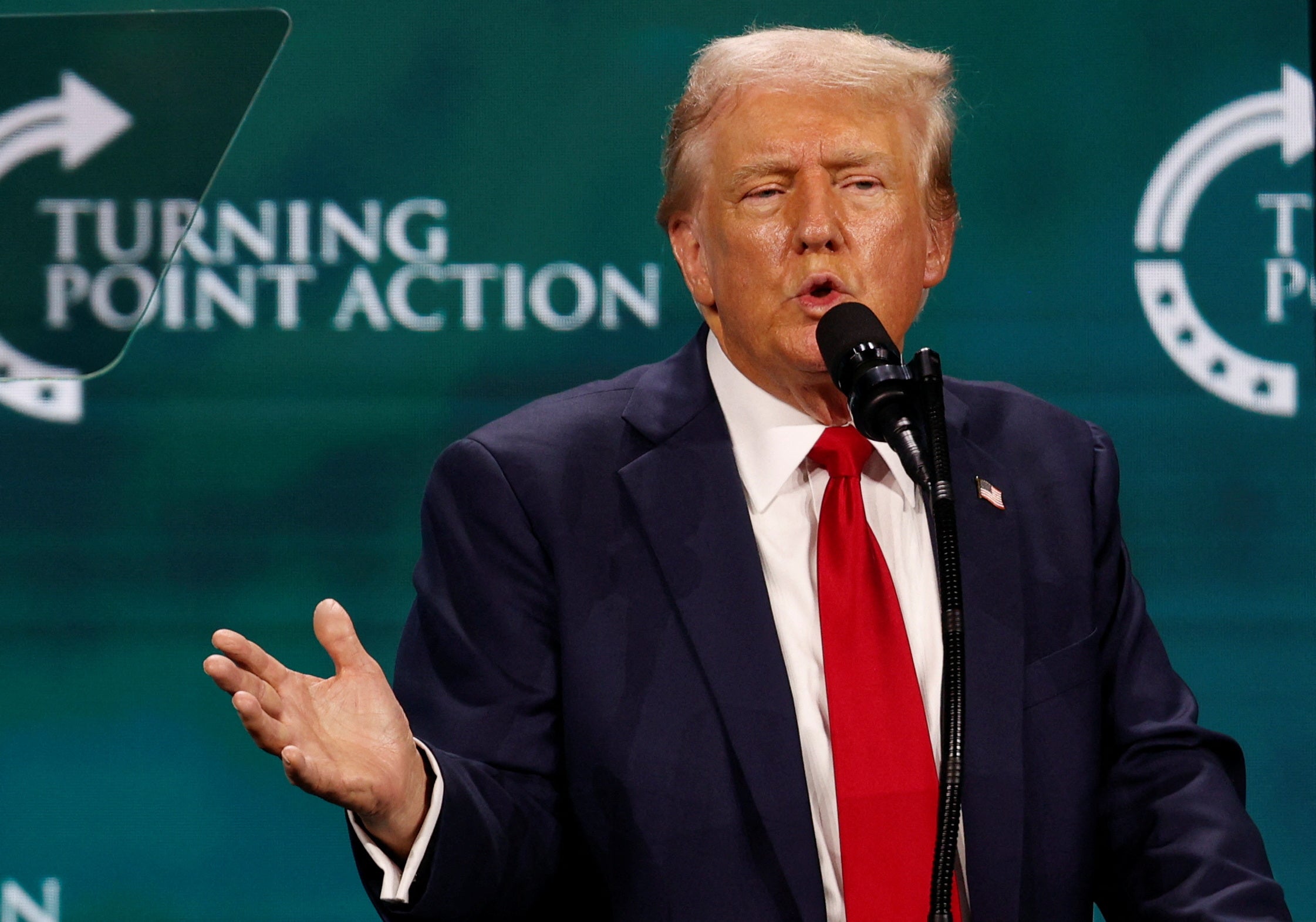 Donald Trump pictured speaking at Turning Point Action’s Believers’ Summit where he told Christians they’d never have to vote again