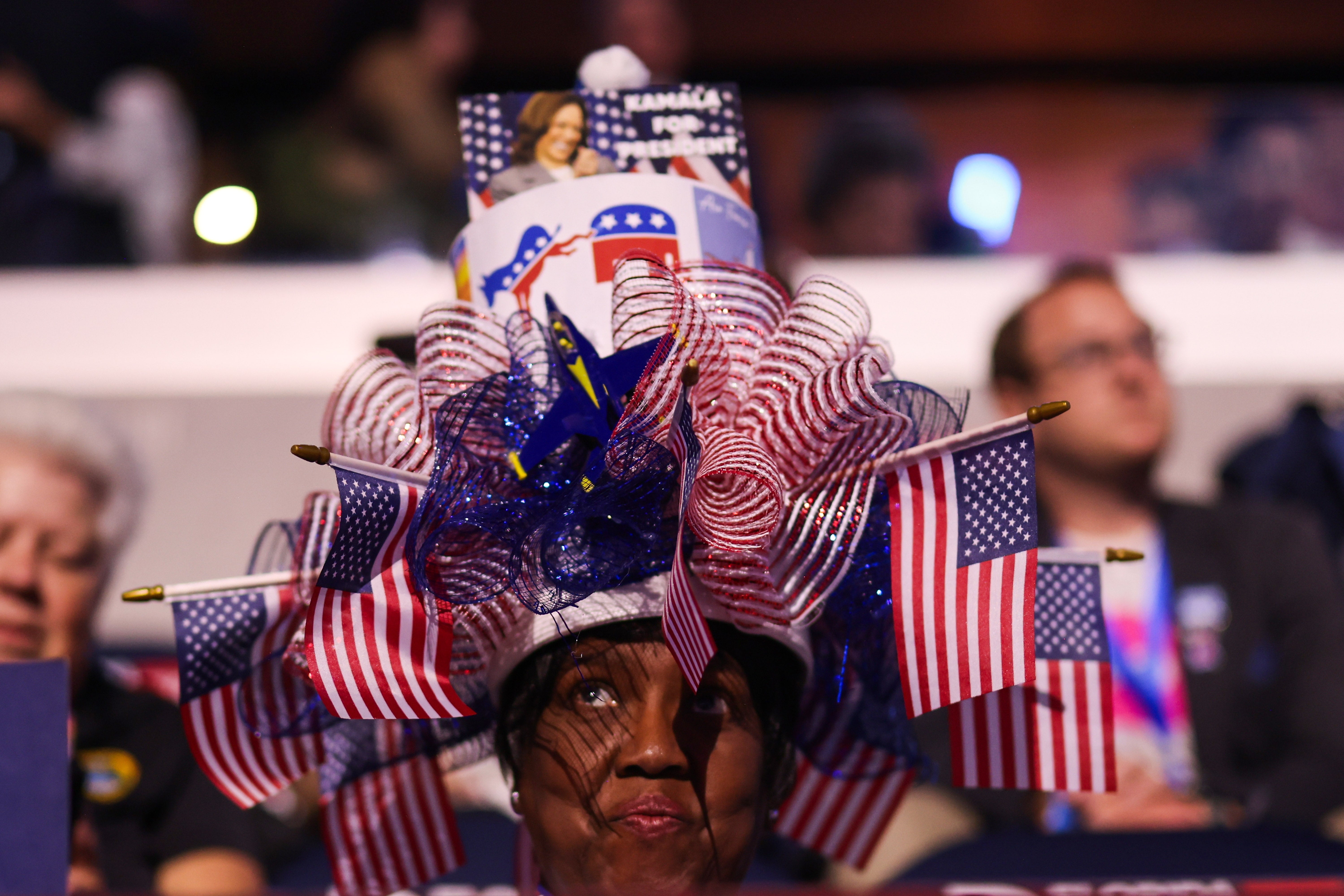 A DNC attendee shows her pride with a hat-adorned red, white and blue hat