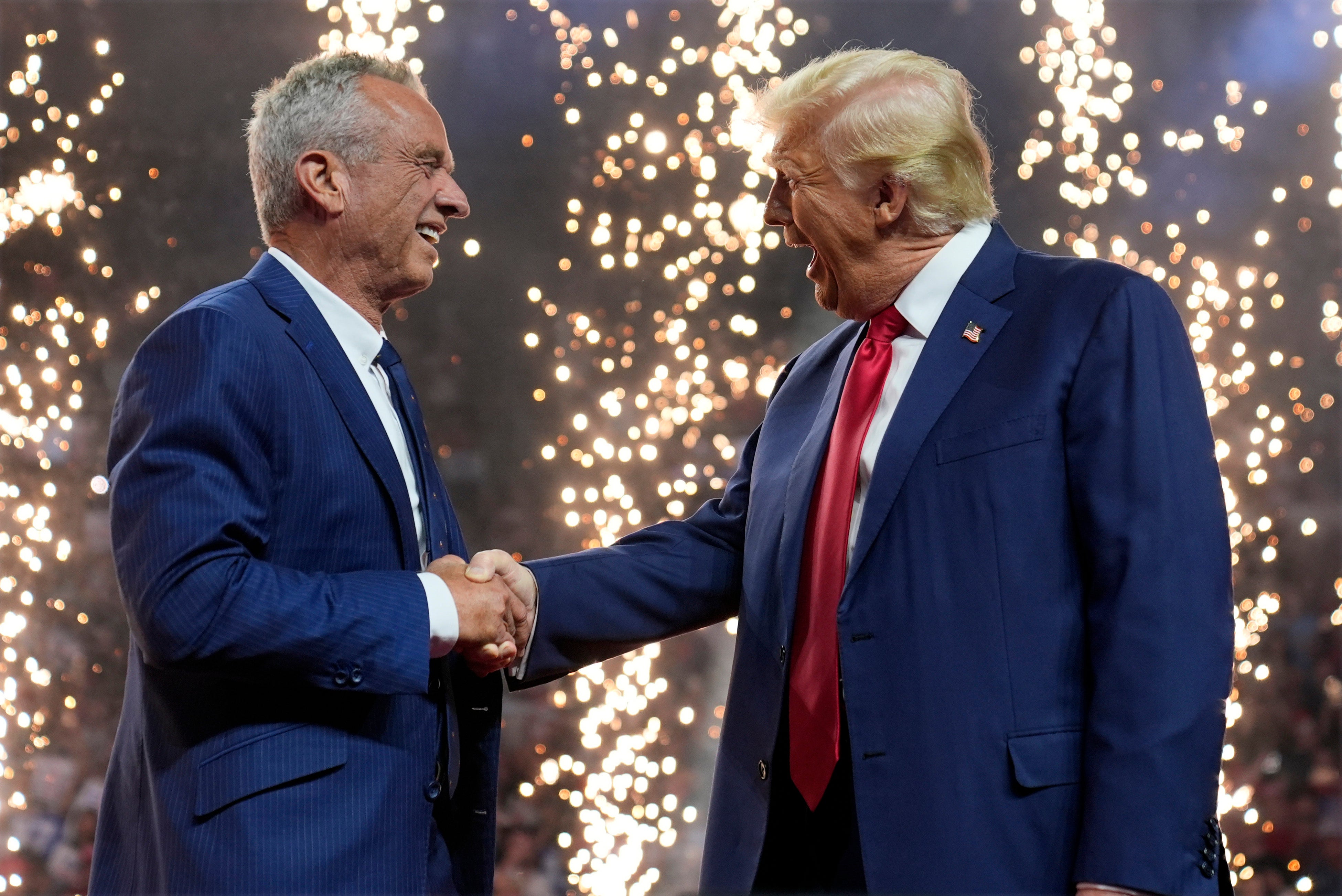 Donald Trump welcomes Robert F Kennedy Jr to the stage in Arizona on Friday while Foo Fighters’ hit song My Hero played