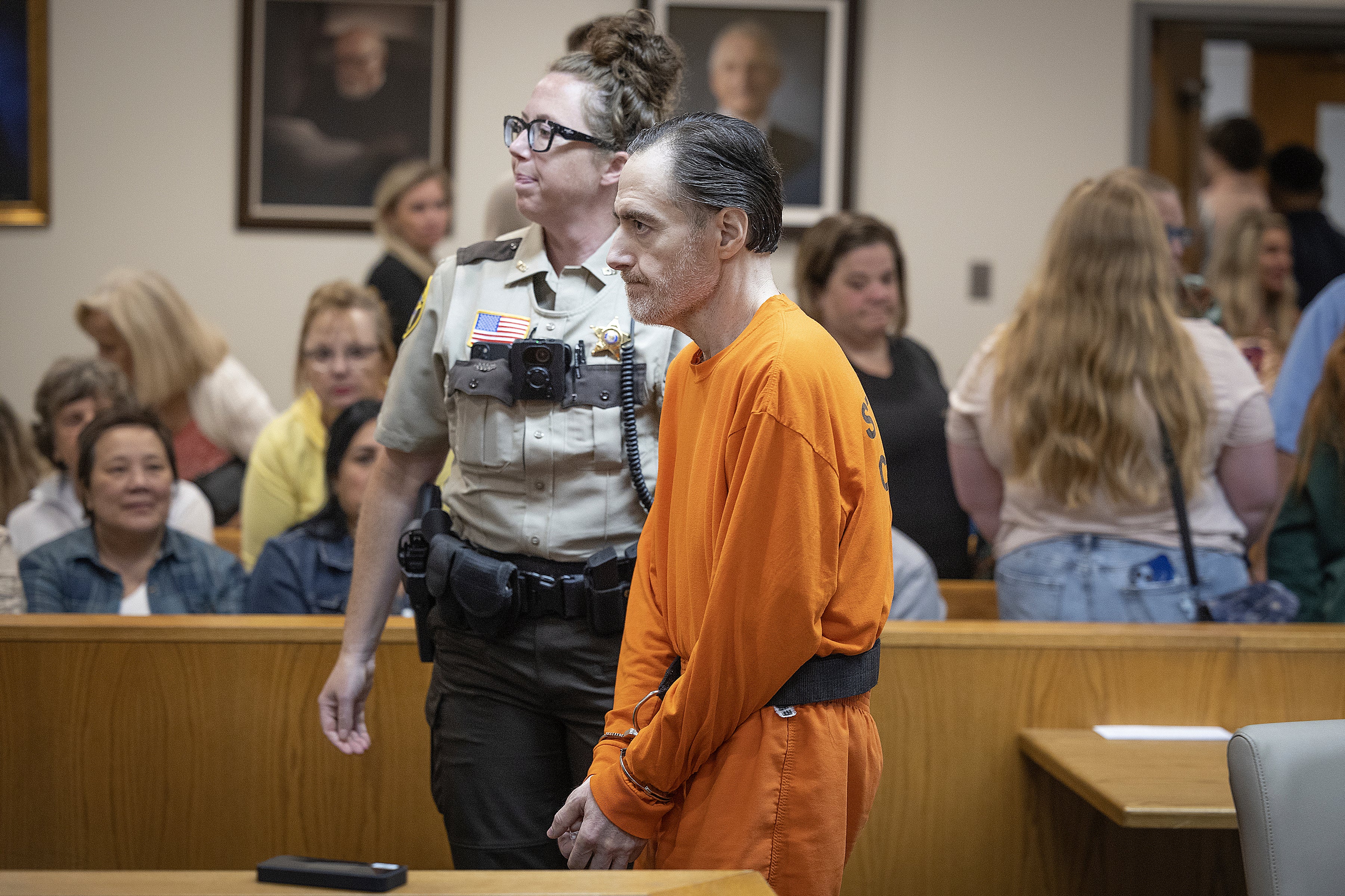 Nicolae Miu is escorted in the courtroom during his sentencing hearing, where he would be hearing impact statements from the victims and their families before he was sentenced to 20 years in prison