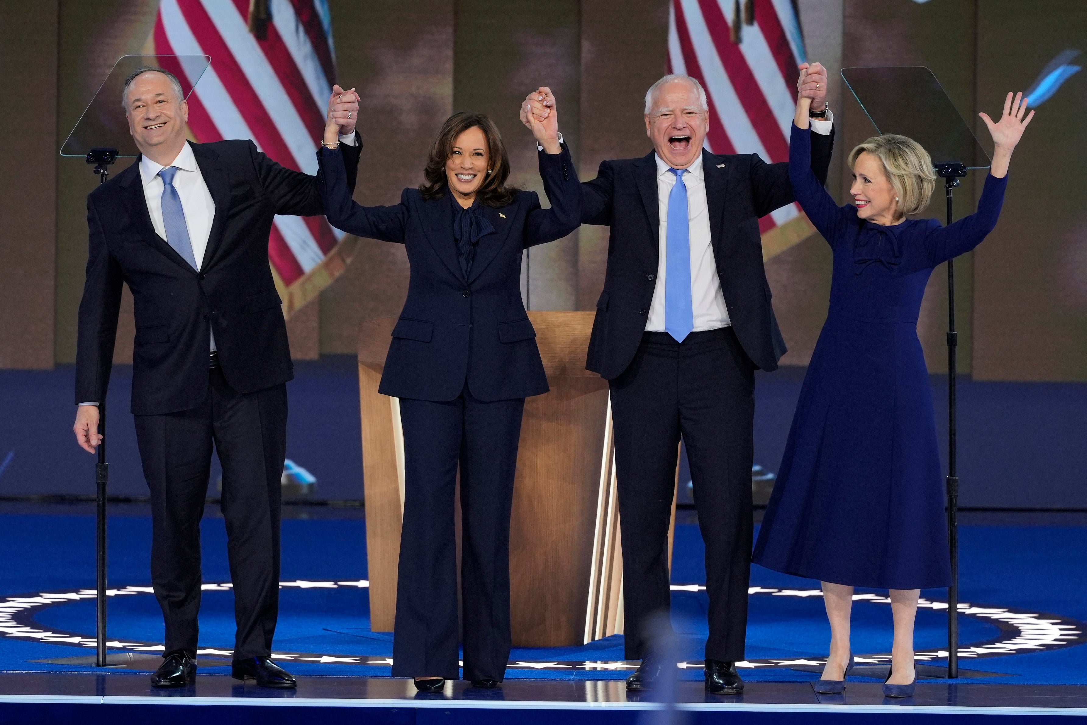 Doug Emhoff, Kamala Harris, Tim Walz and his wife Gwen Walz on stage together